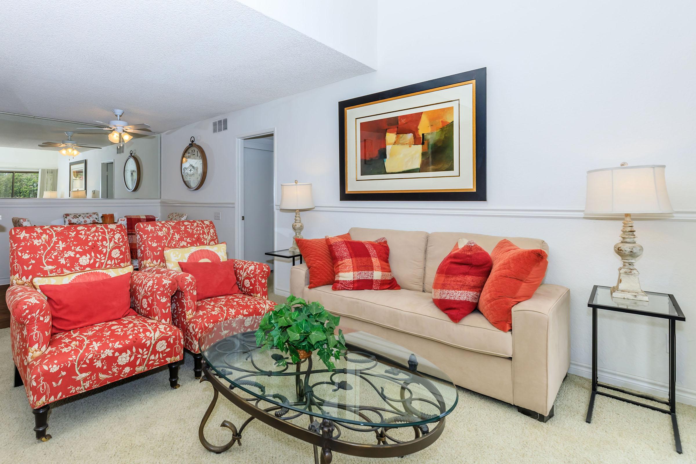 a living room filled with furniture and a flat screen tv