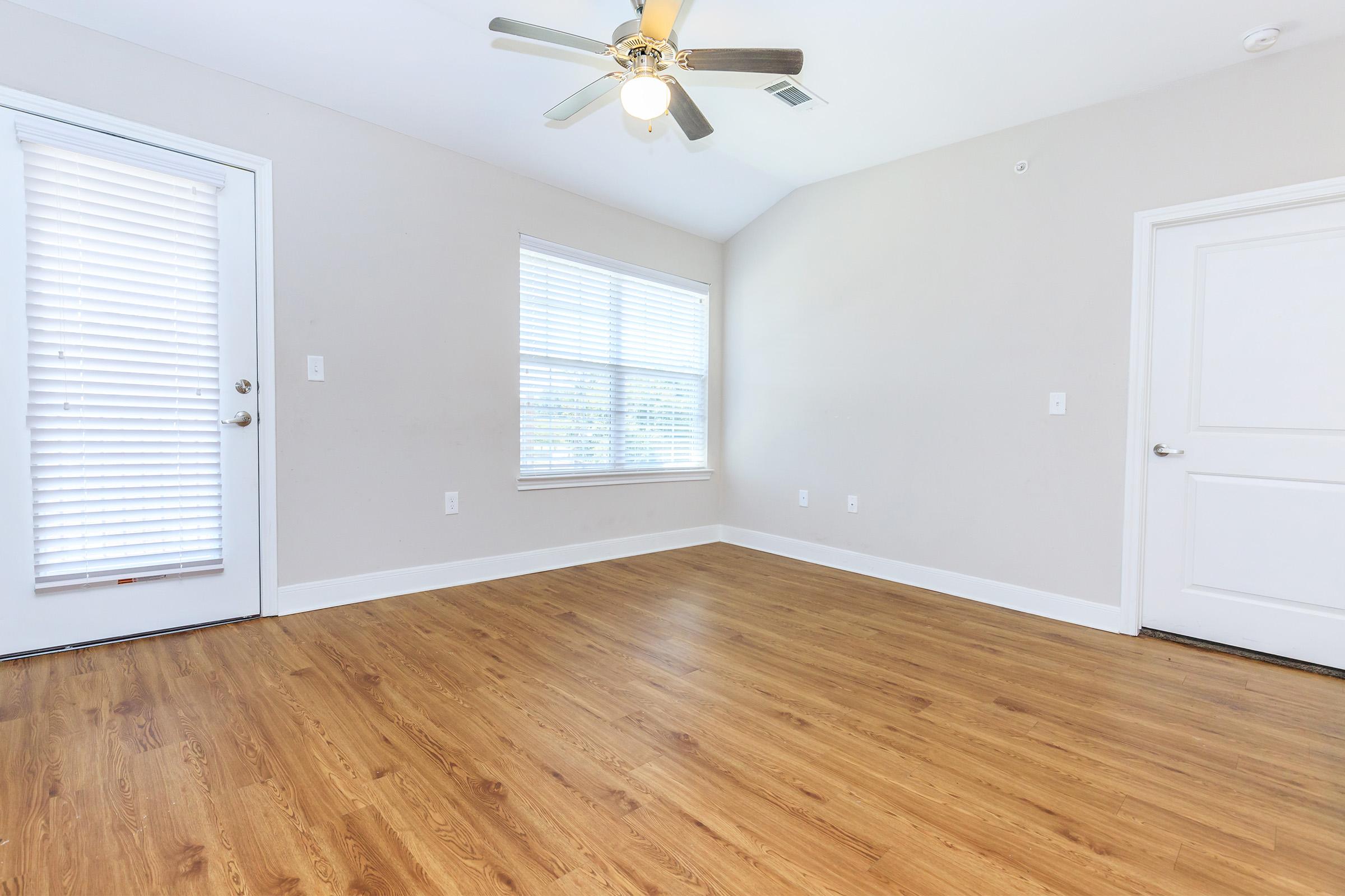 a close up of a hard wood floor next to a window