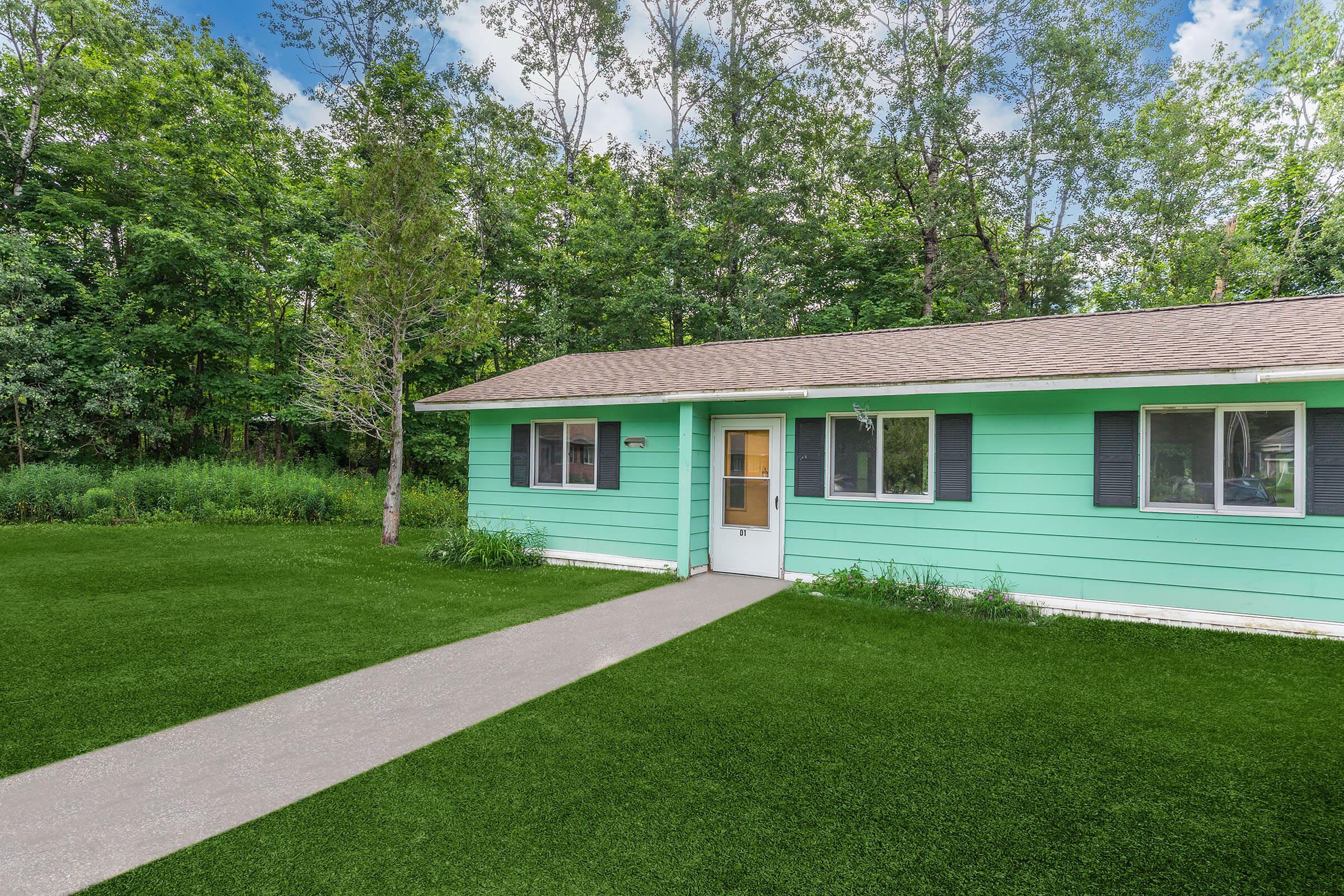 a green lawn in front of a house