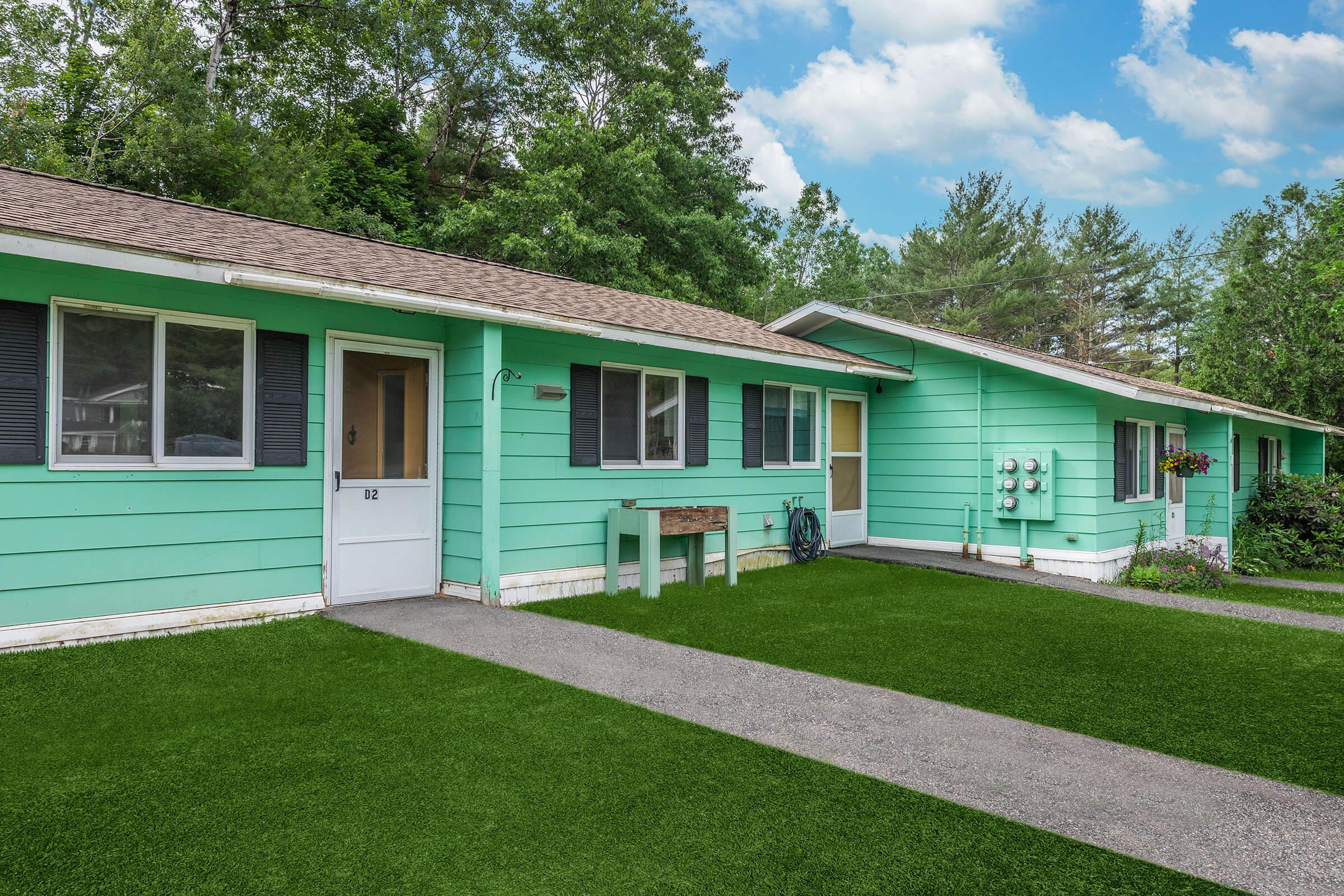 a green lawn in front of a house