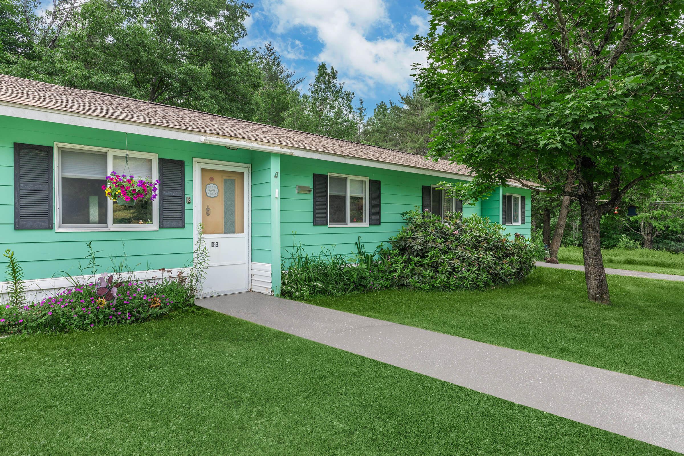 a green lawn in front of a house