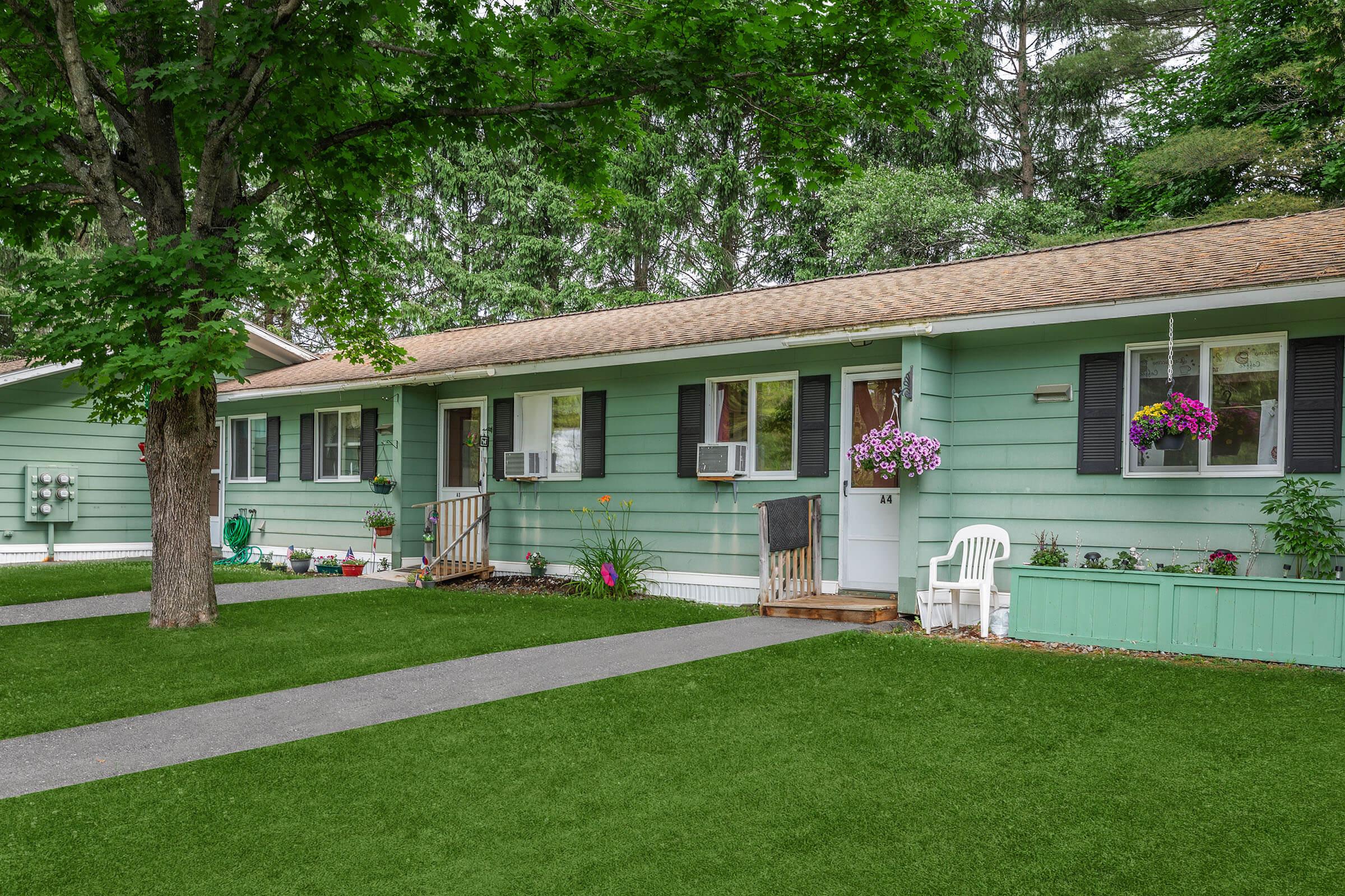 a green lawn in front of a house