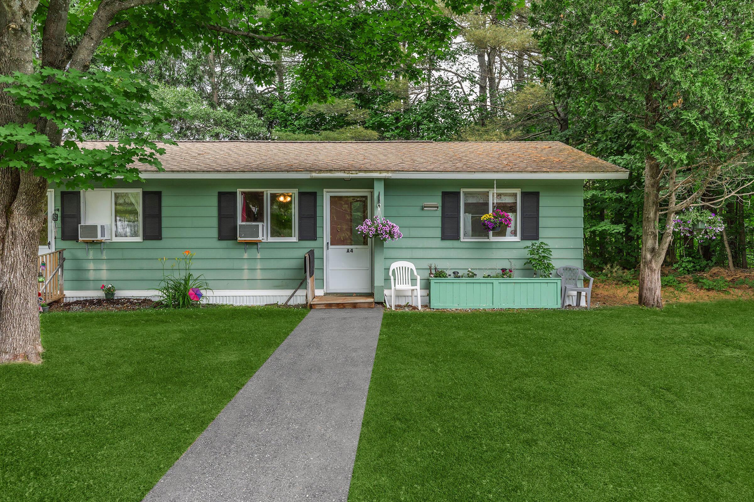 a green lawn in front of a house