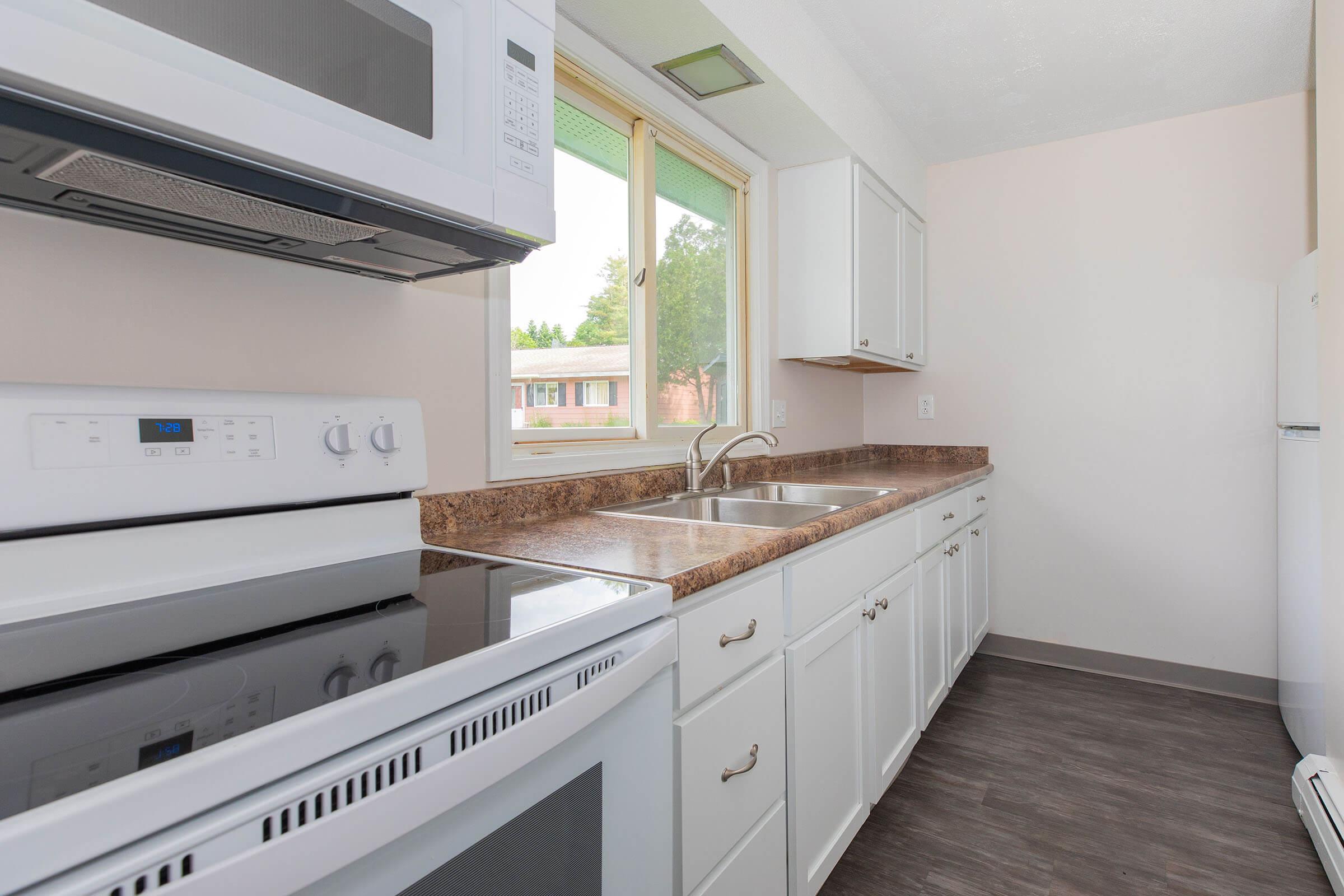 a stove top oven sitting inside of a kitchen