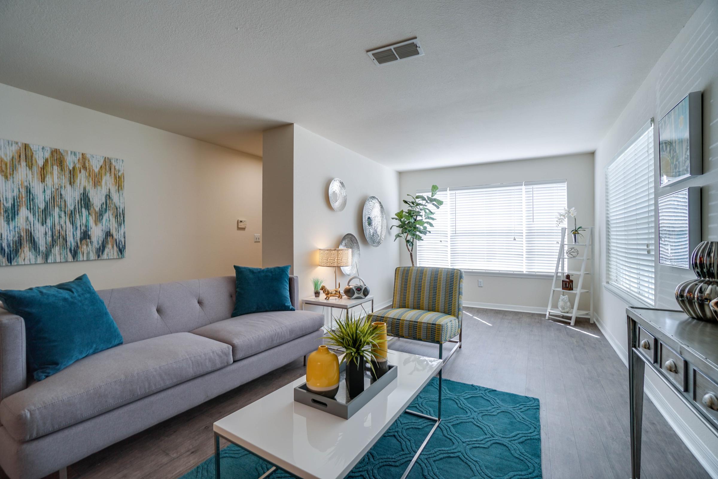 a living room filled with furniture and a large window