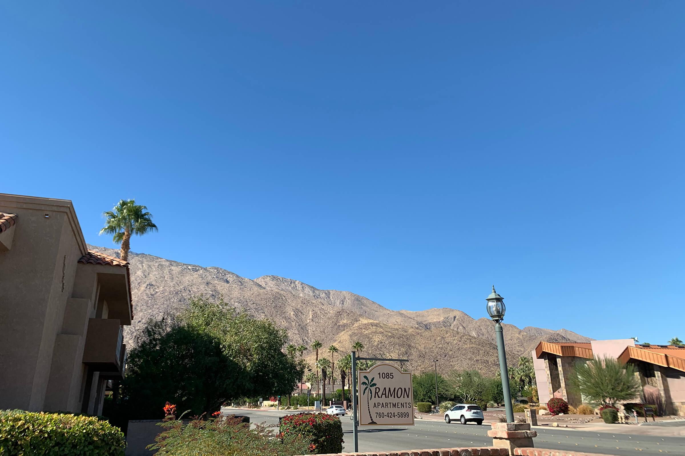 a large brick building with a mountain in the background