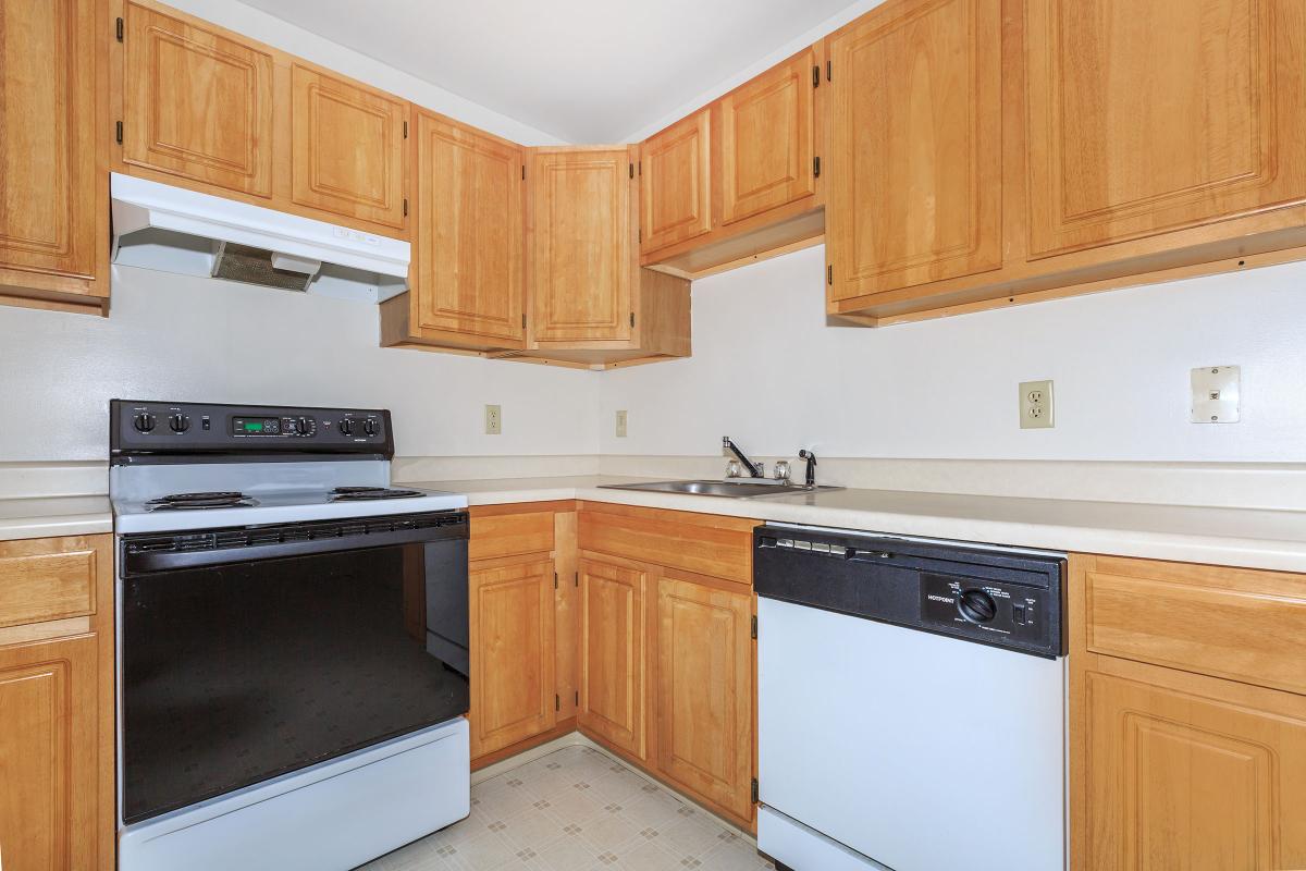 a kitchen with wooden cabinets and a microwave