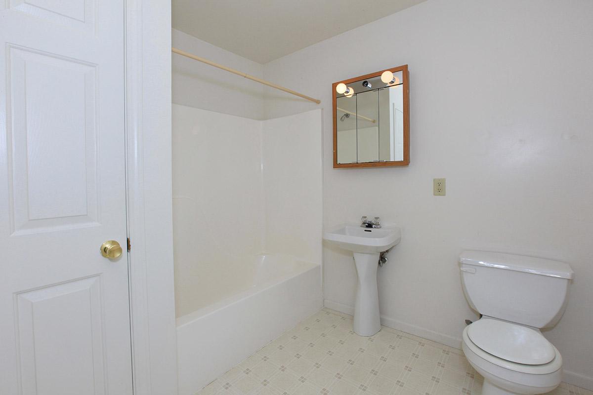 a white tub sitting next to a shower