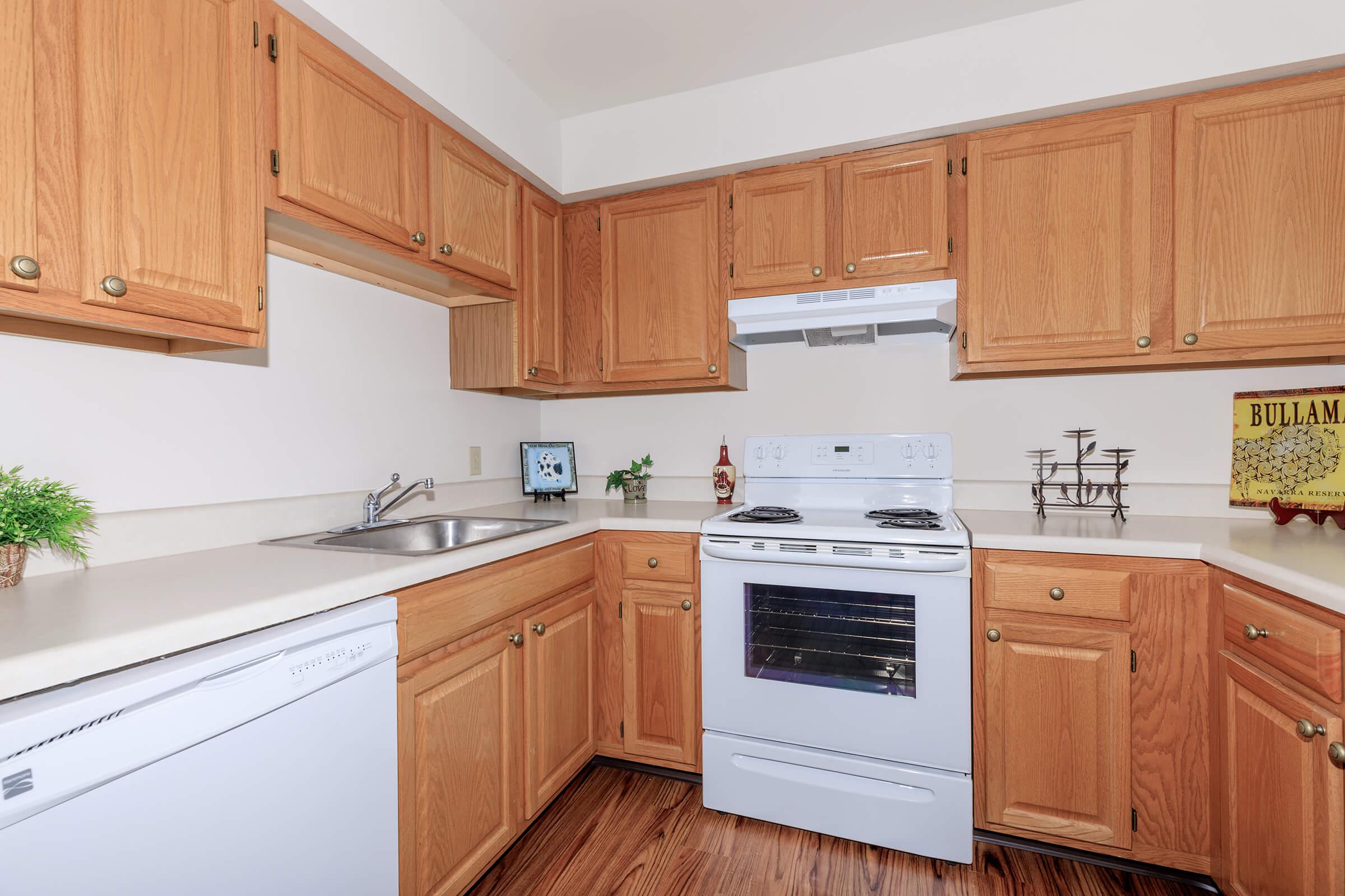 a kitchen with wooden cabinets and a microwave