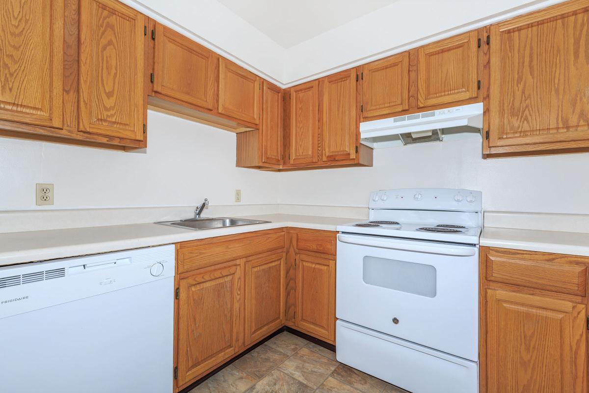 a kitchen with wooden cabinets and a microwave