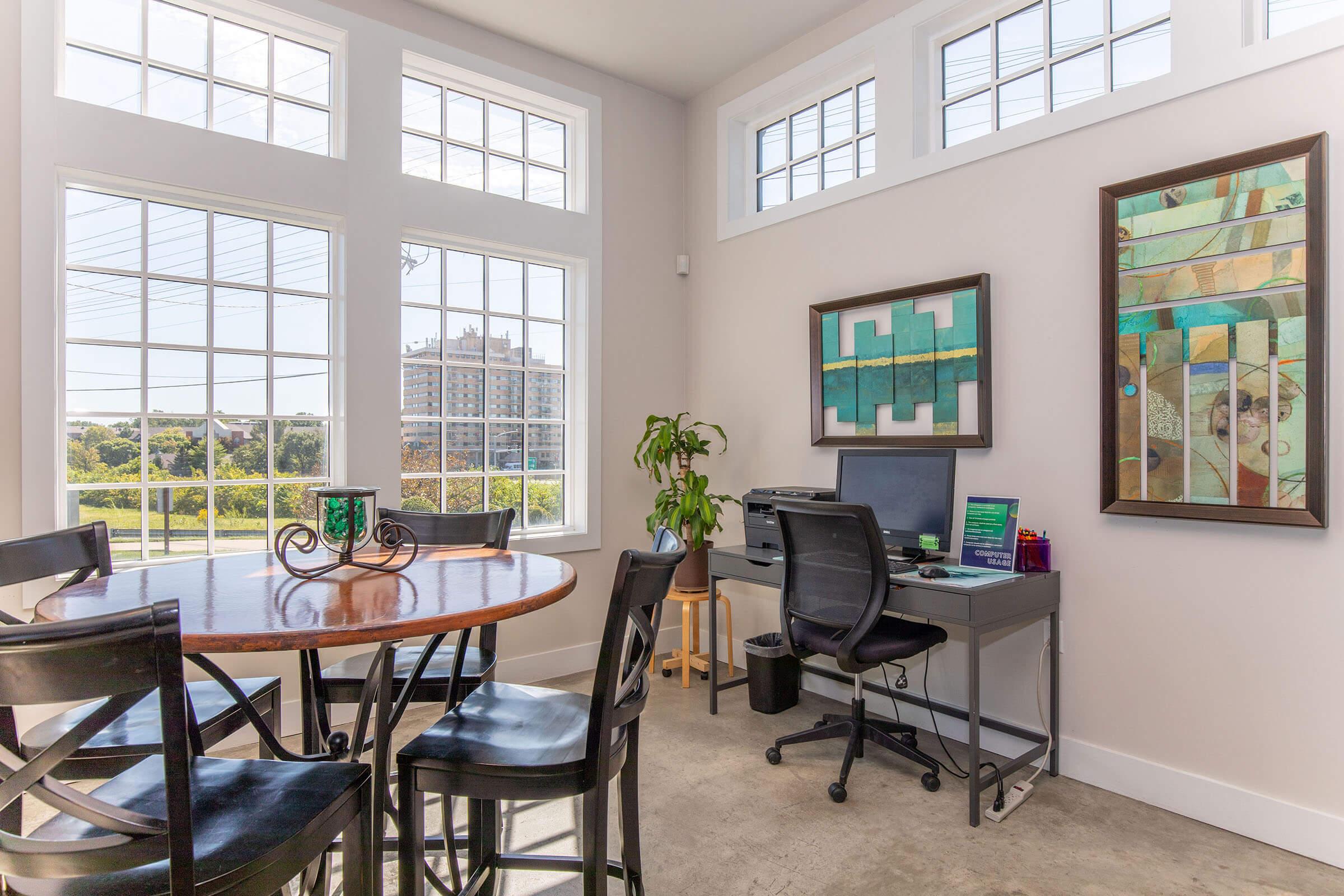 a living room filled with furniture and a large window