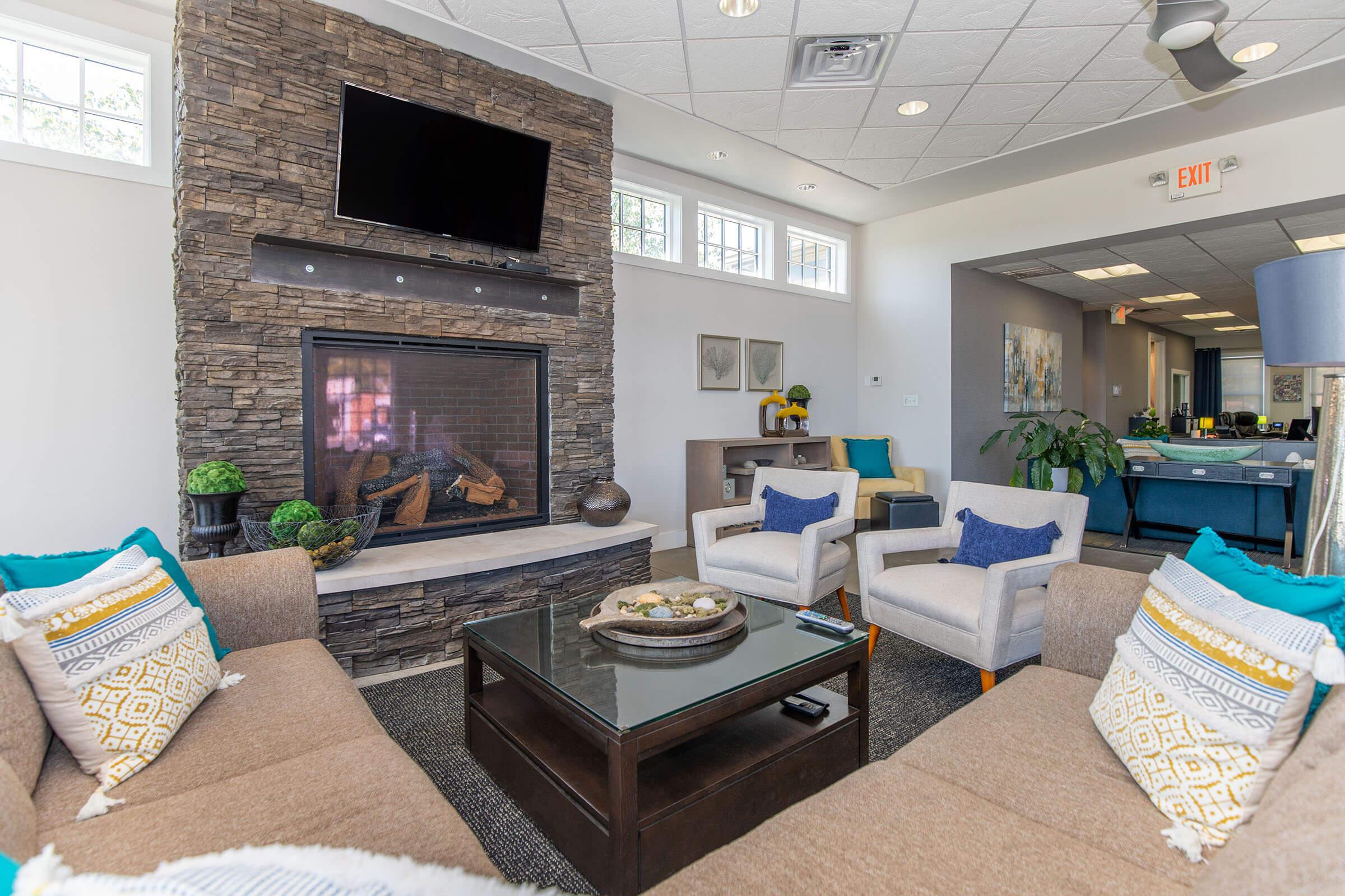 a living room filled with furniture and a fire place