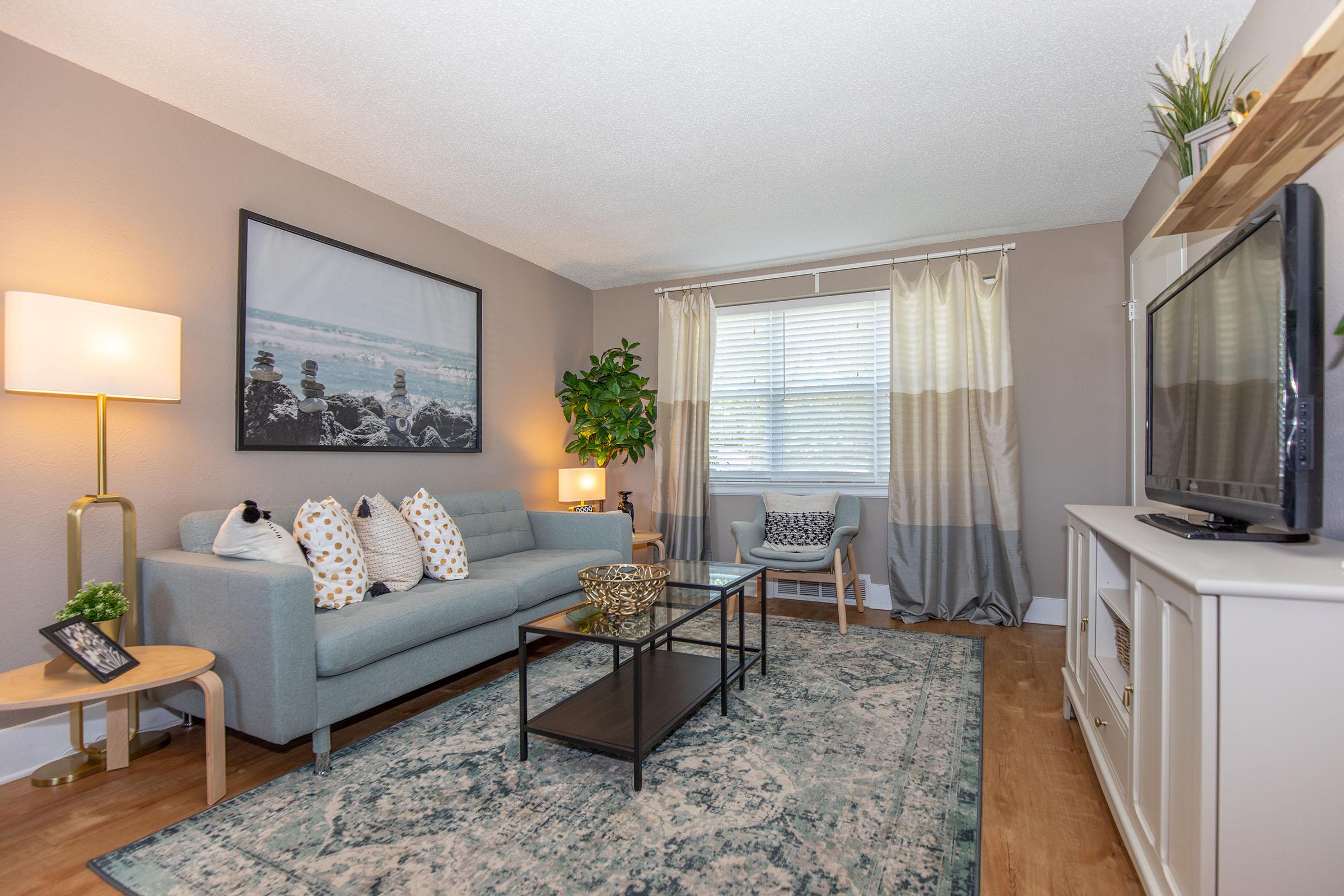 a living room filled with furniture and a large window