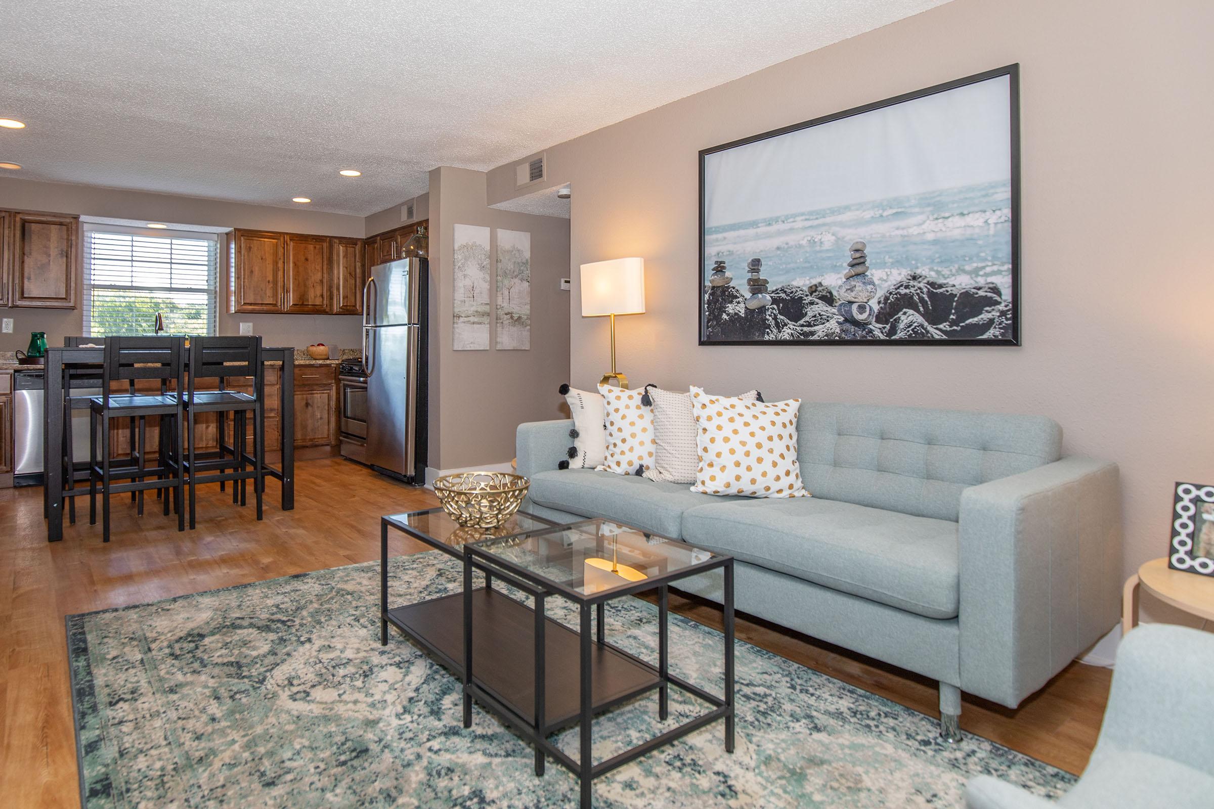 a living room filled with furniture and a large window