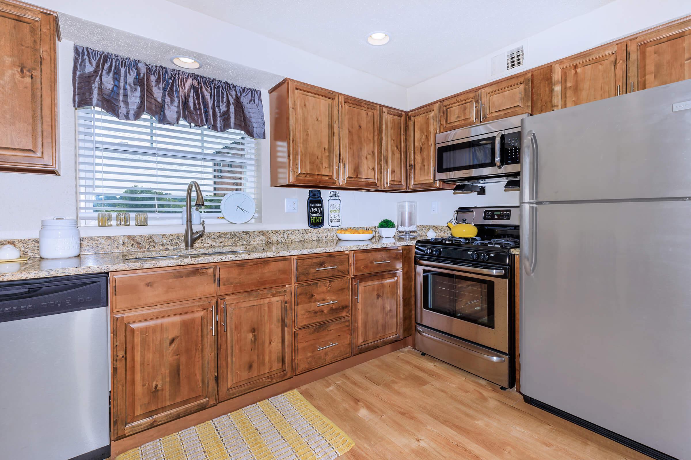 a kitchen with stainless steel appliances and wooden cabinets