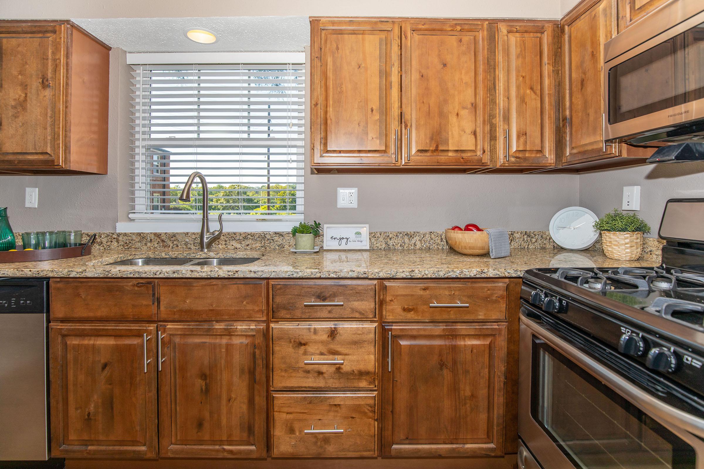 a kitchen with a stove top oven sitting inside of a wooden counter