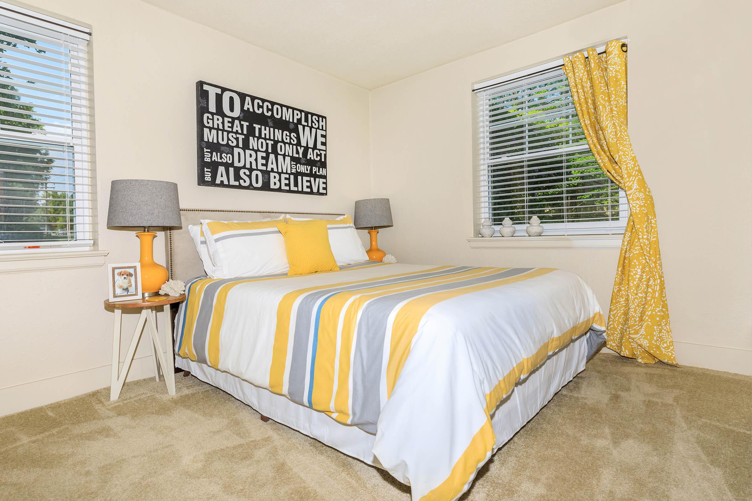 a bedroom with a bed in a room