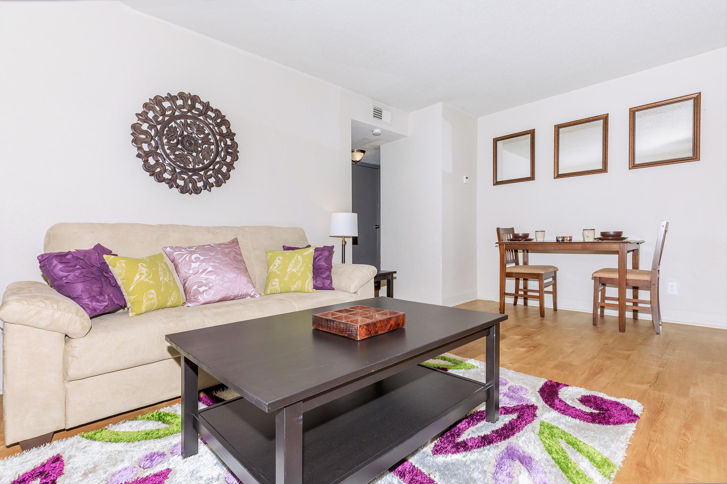 a living room filled with furniture and a rug