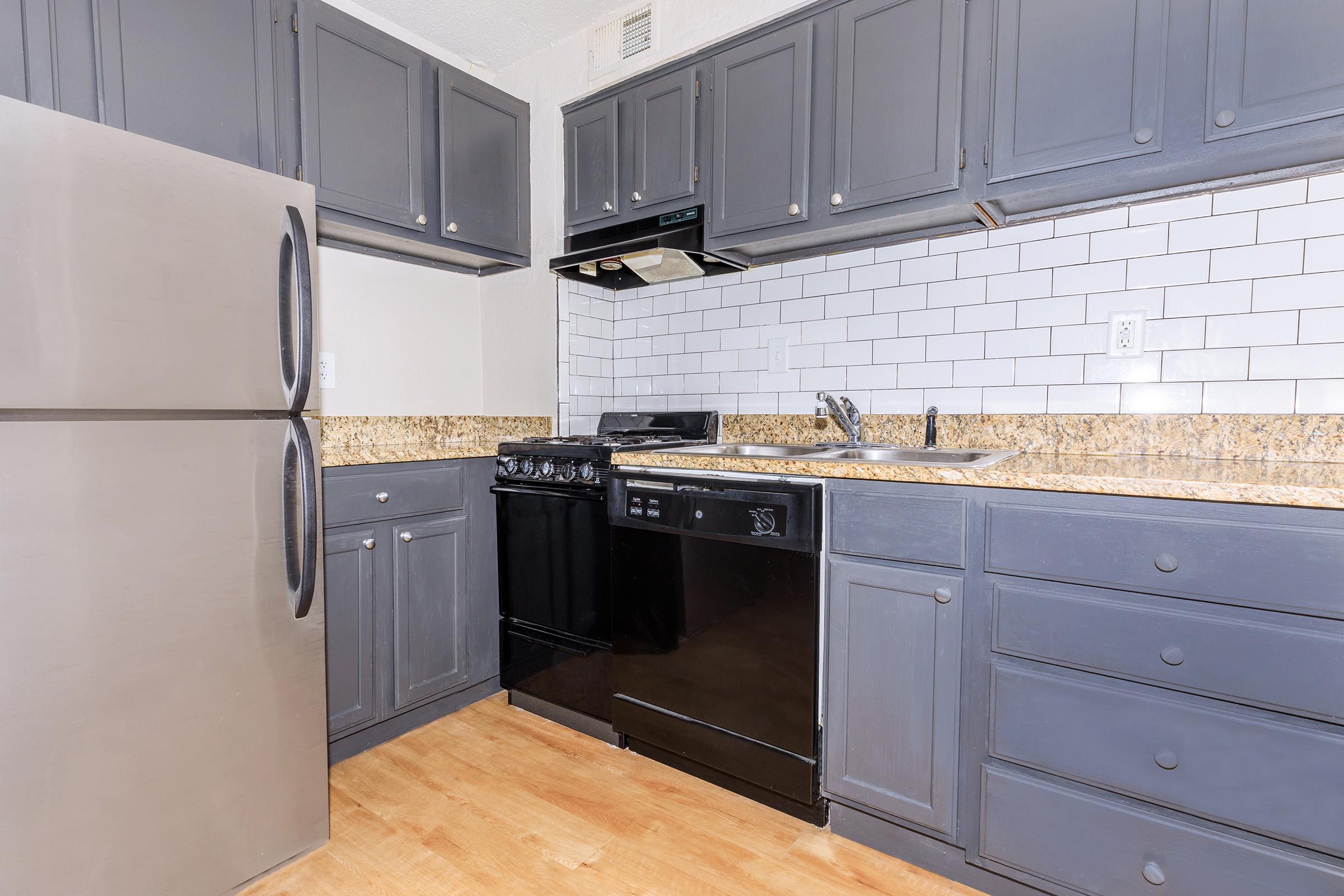 a kitchen with a stove and a refrigerator