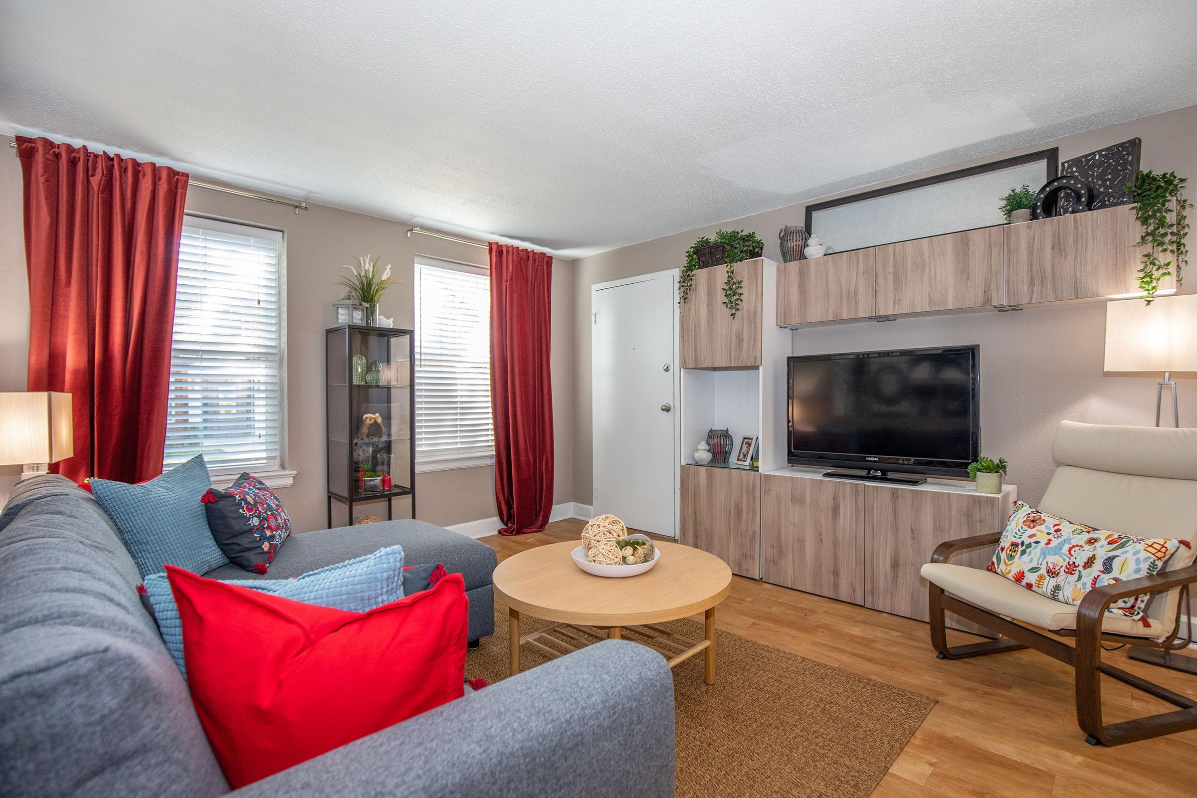 a living room filled with furniture and a flat screen tv