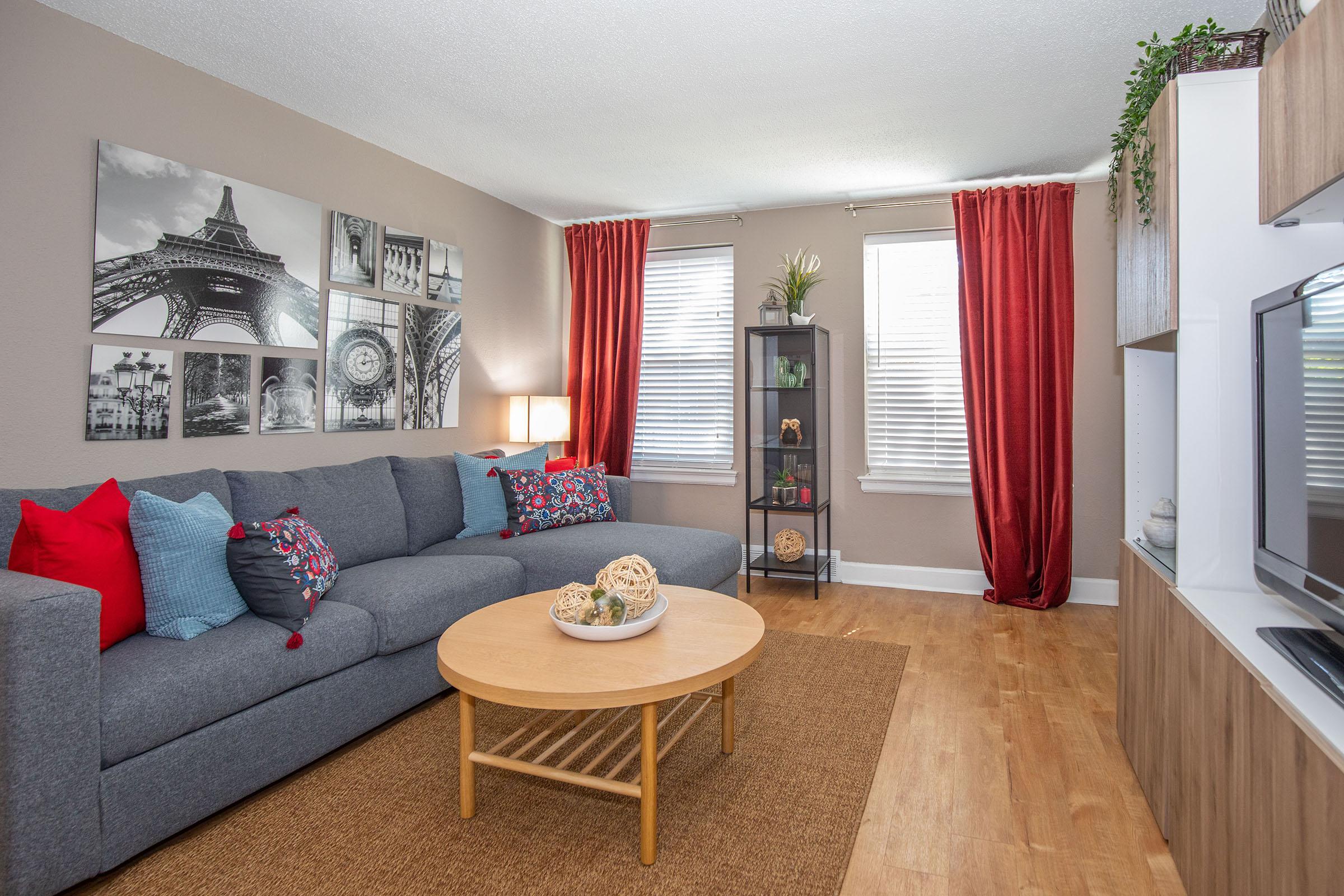 a living room filled with furniture and a flat screen tv