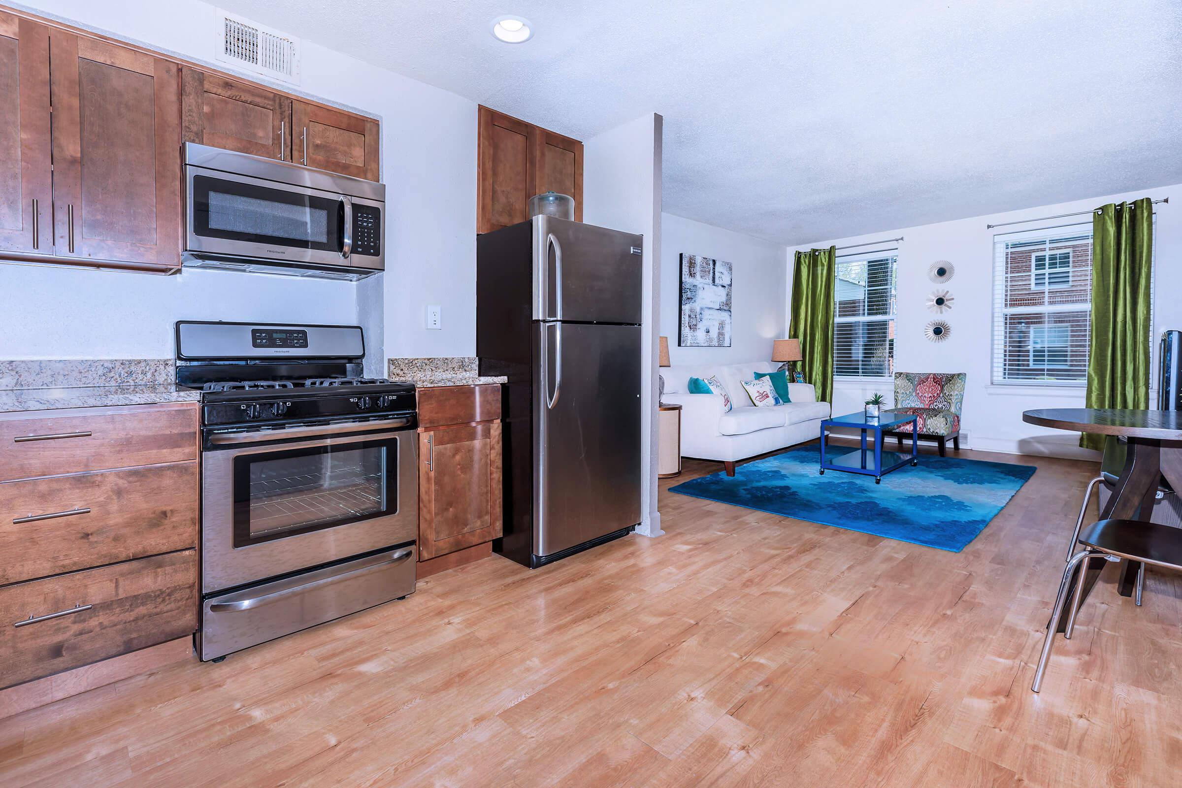 a kitchen with a stove top oven sitting inside of a room