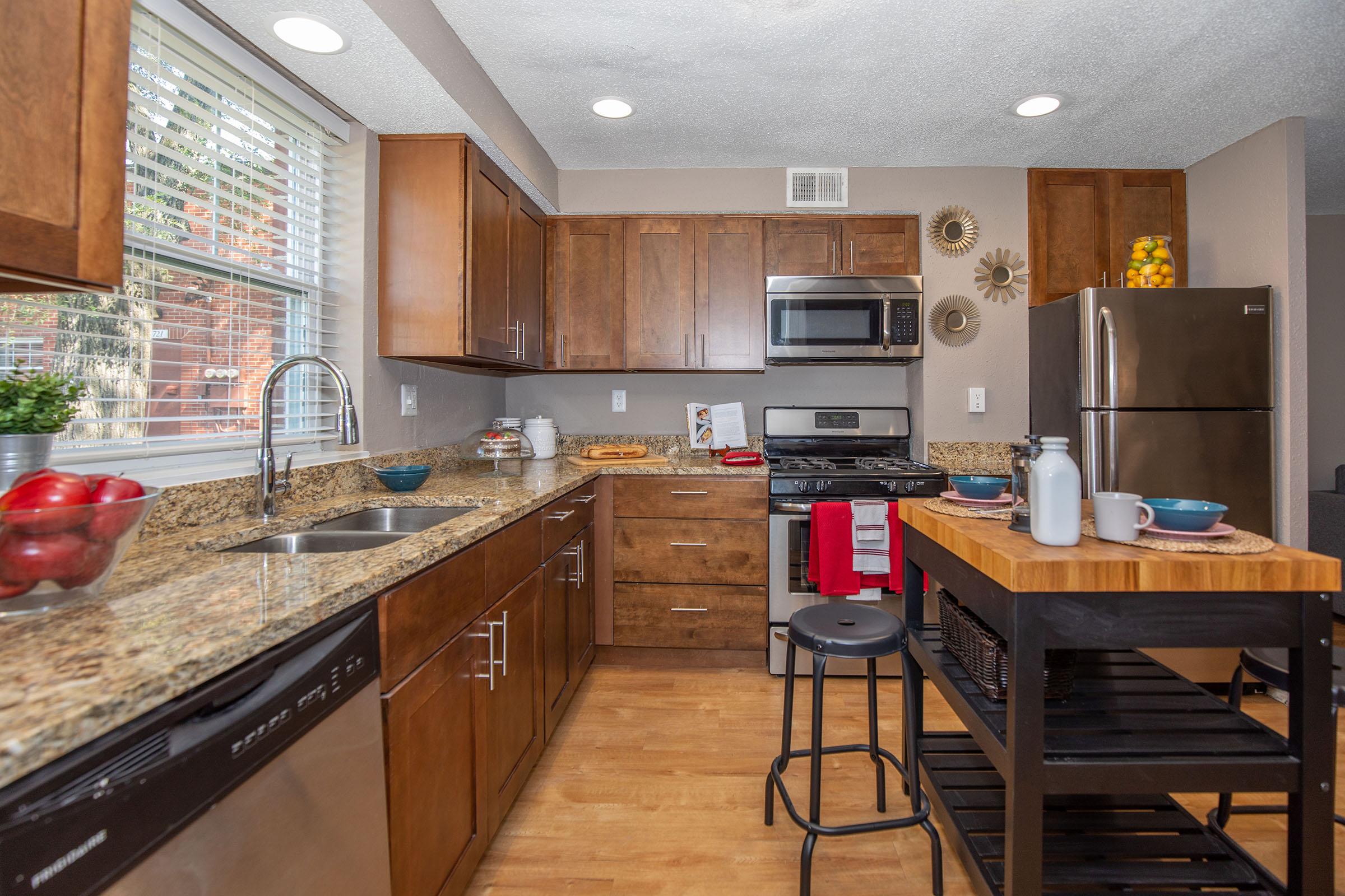 a modern kitchen with stainless steel appliances and wooden cabinets