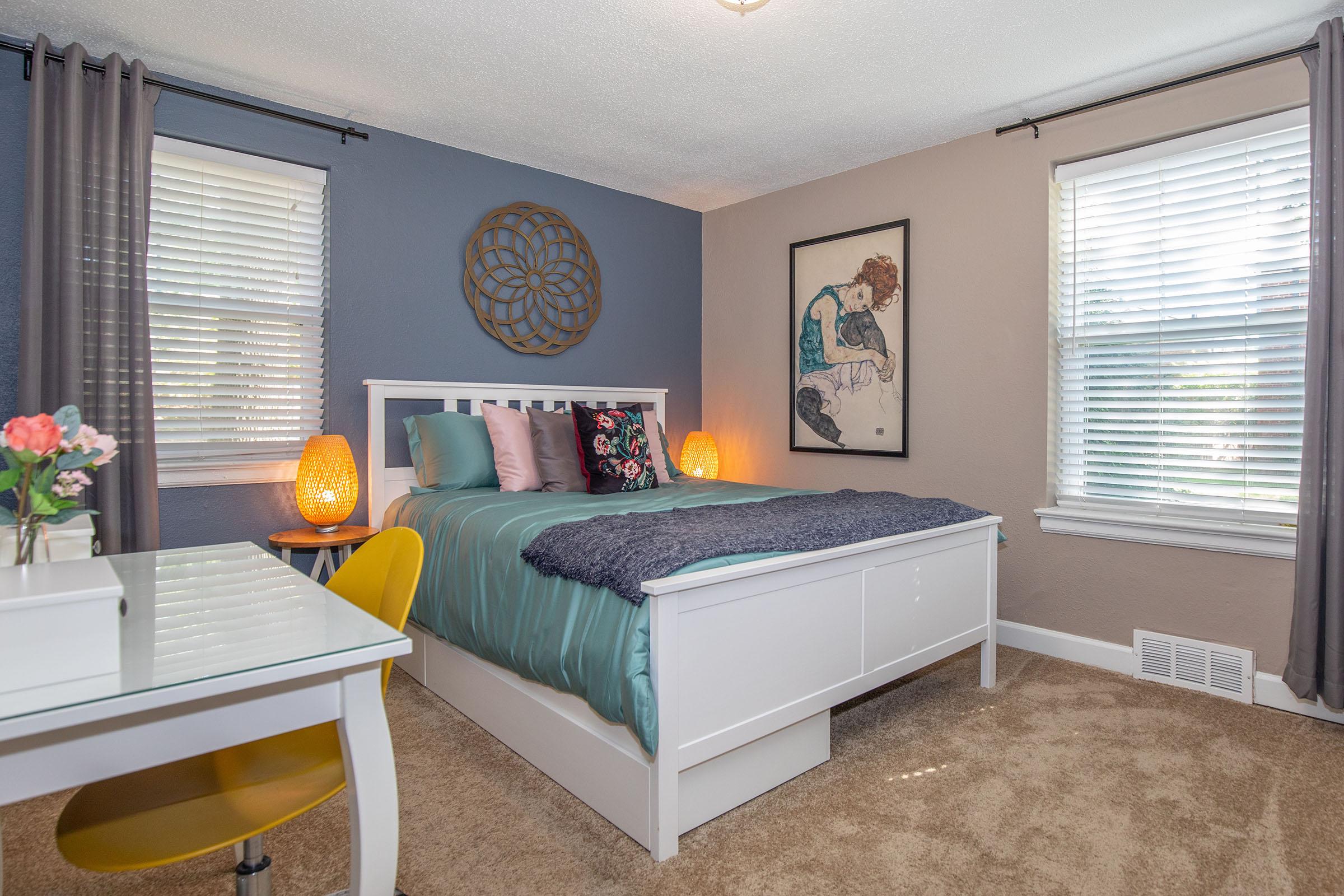 a living room with a bed and a window