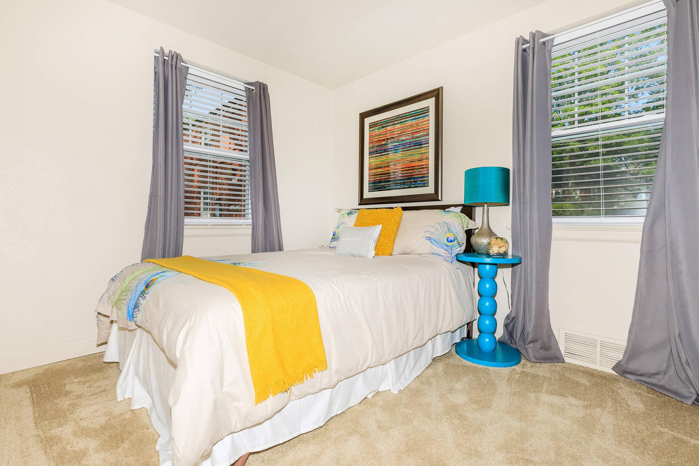 a bedroom with a bed in a room