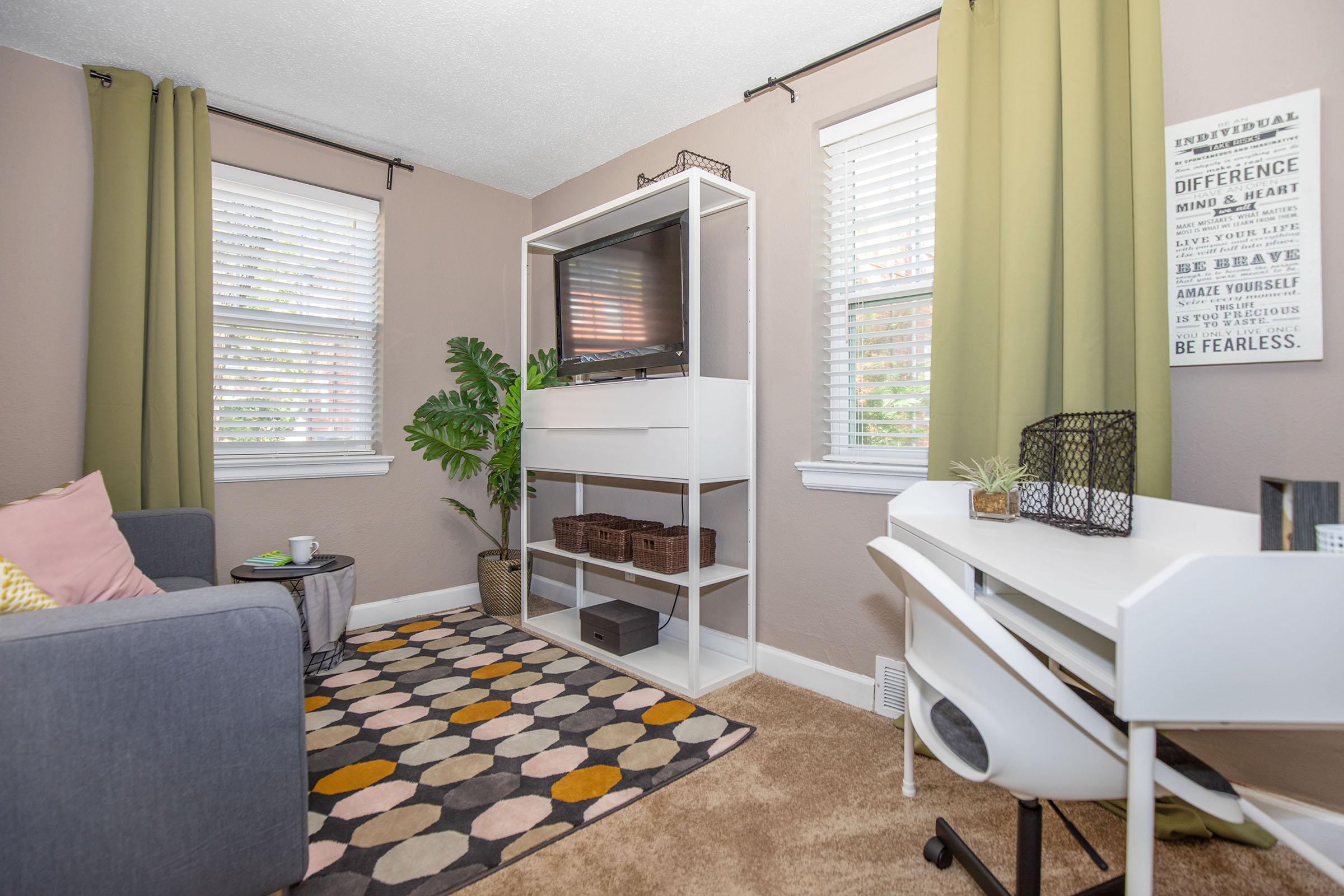 a living room filled with furniture and a large window