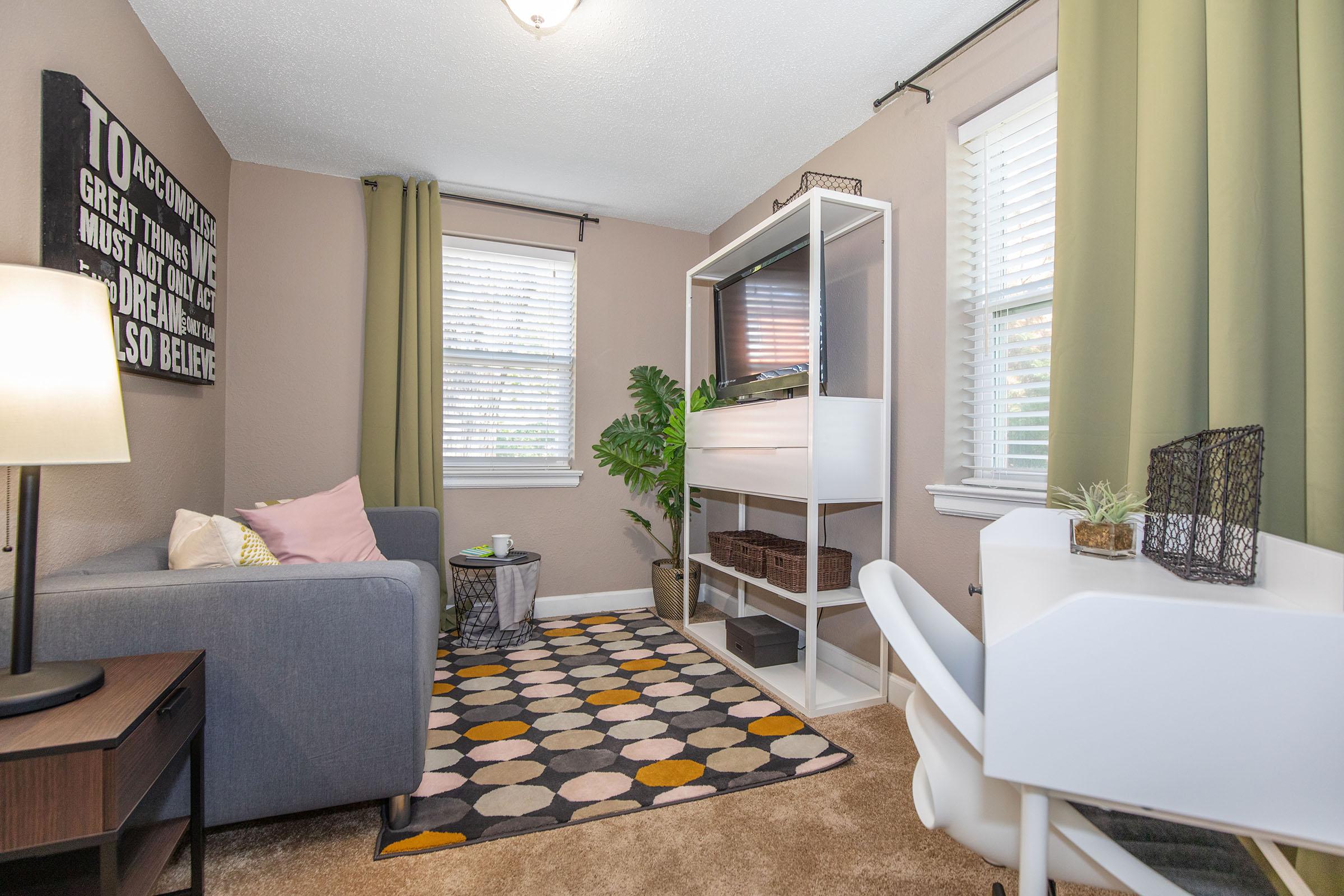 a living room filled with furniture and a large window