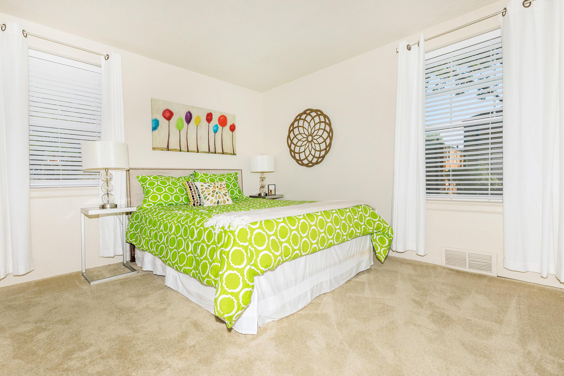 a bedroom with a bed in a room