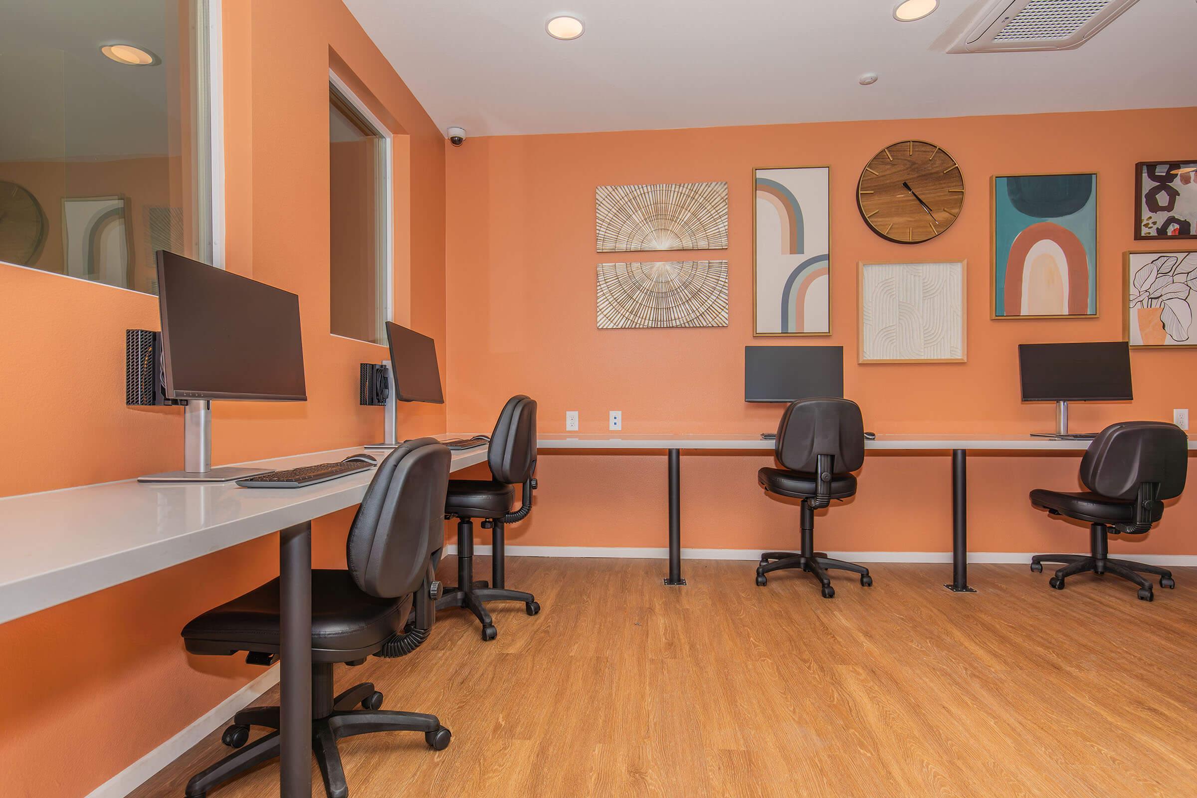 an office with a desk and chair in a room