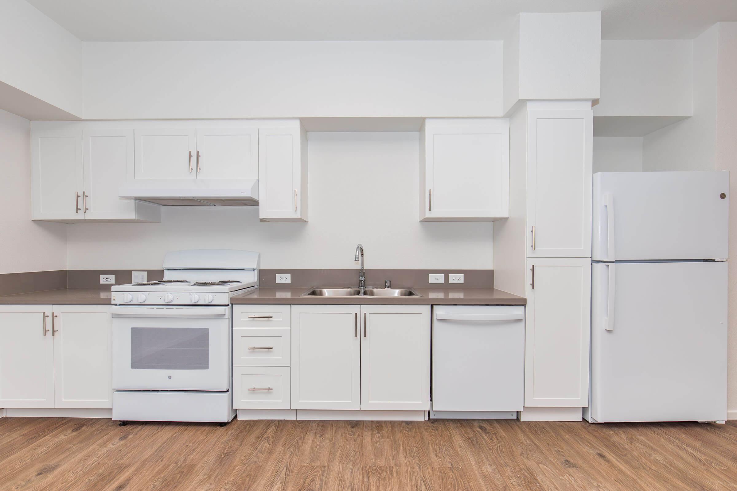 a stove top oven sitting inside of a kitchen