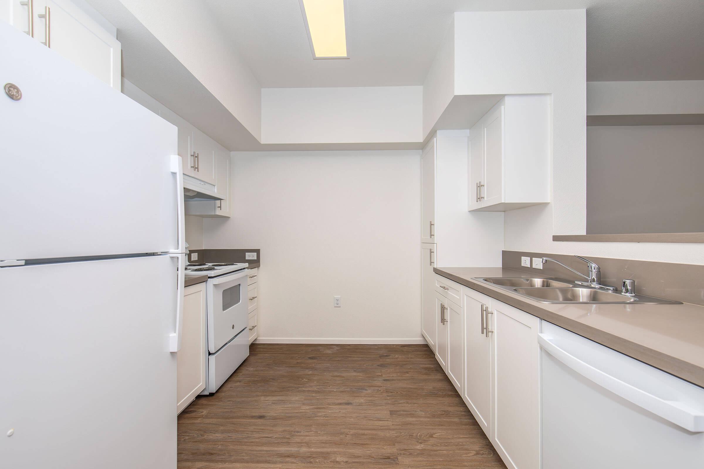 a kitchen with a sink and a refrigerator