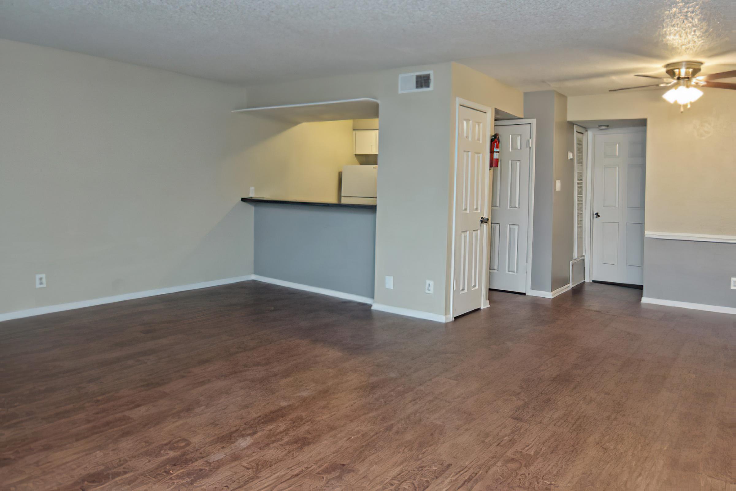 a large empty room with a wood floor