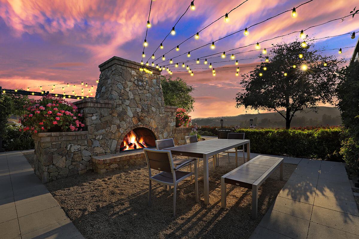Lit outdoor fireplace at night