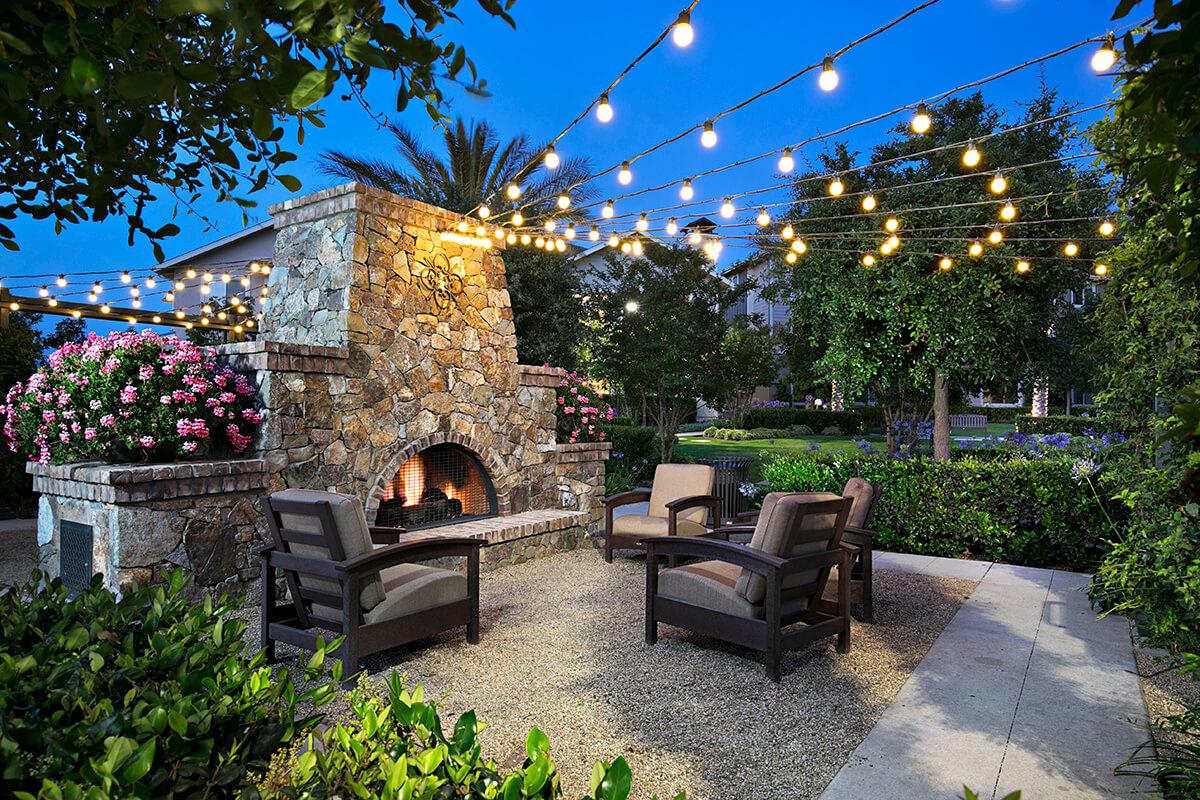 Sendero Gateway Apartment Homes outdoor fireplace at night