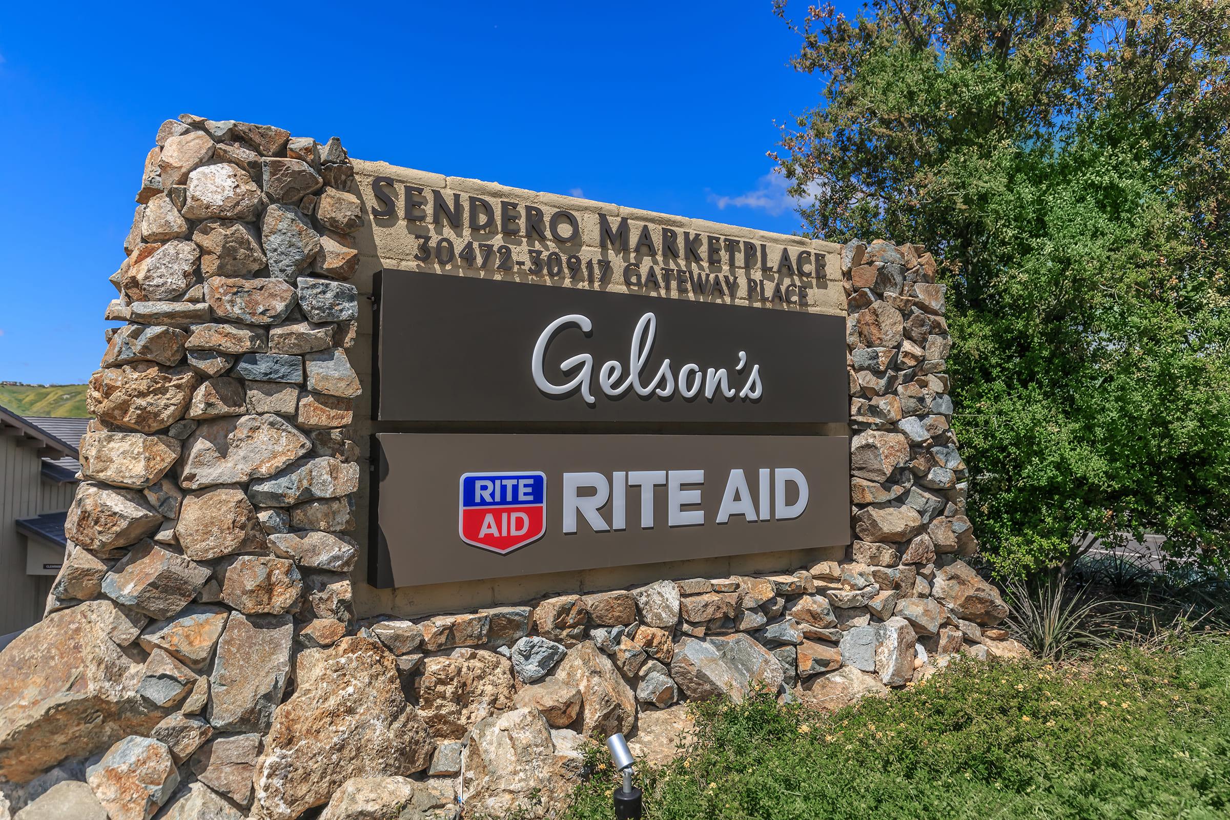 a stone building that has a sign on a rock