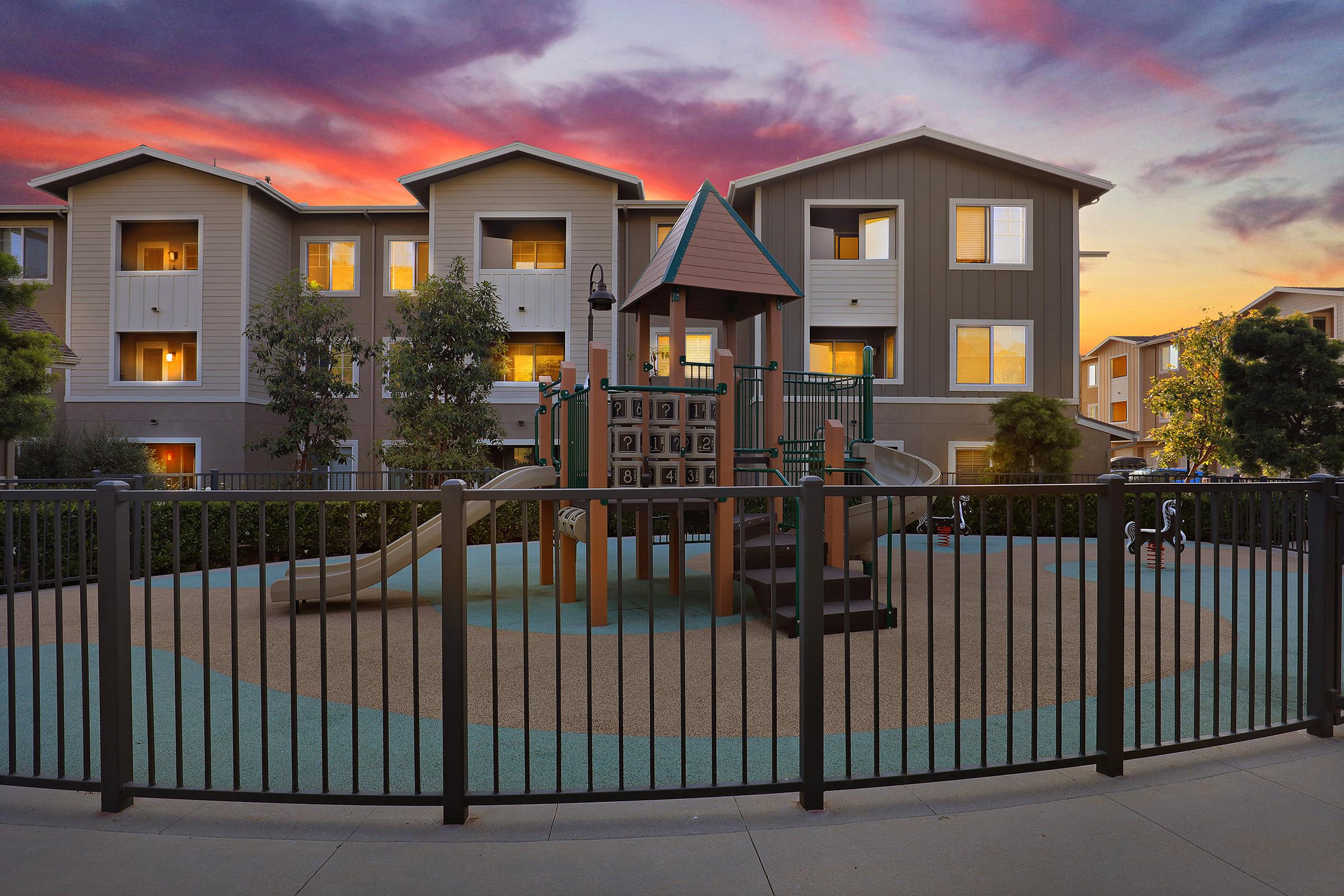 a house with a fence in front of a building