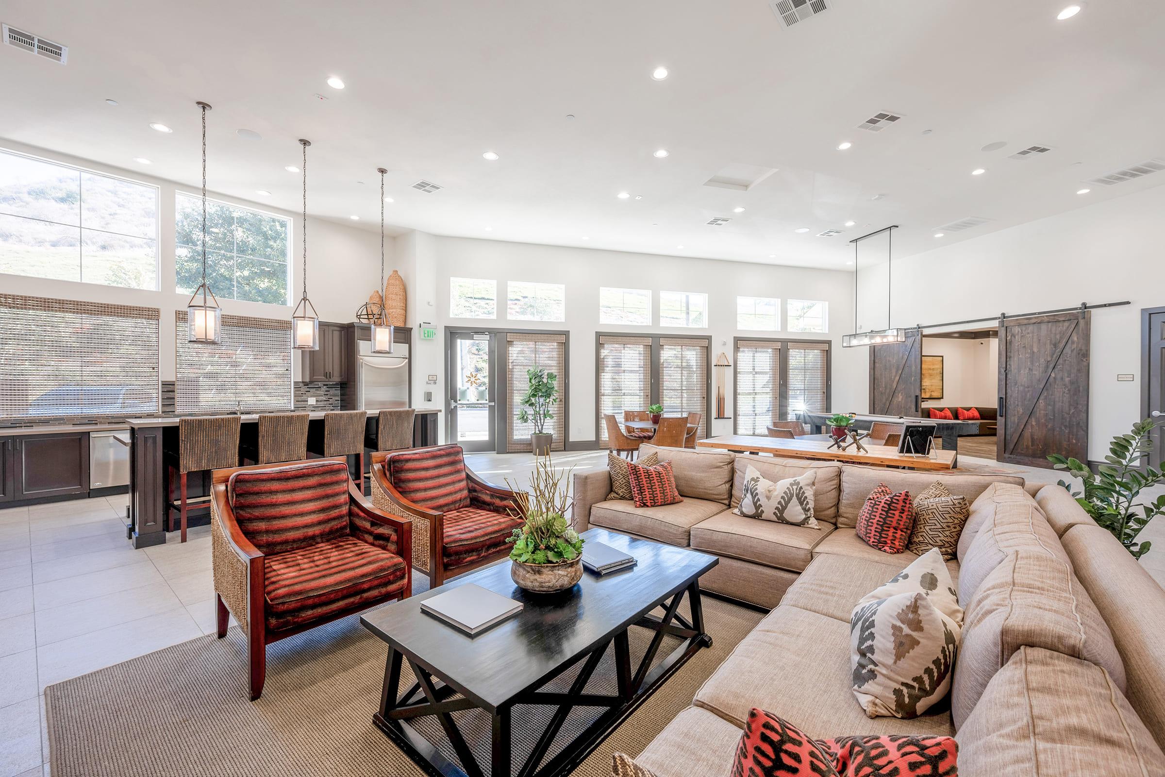 a living room filled with furniture and a large window