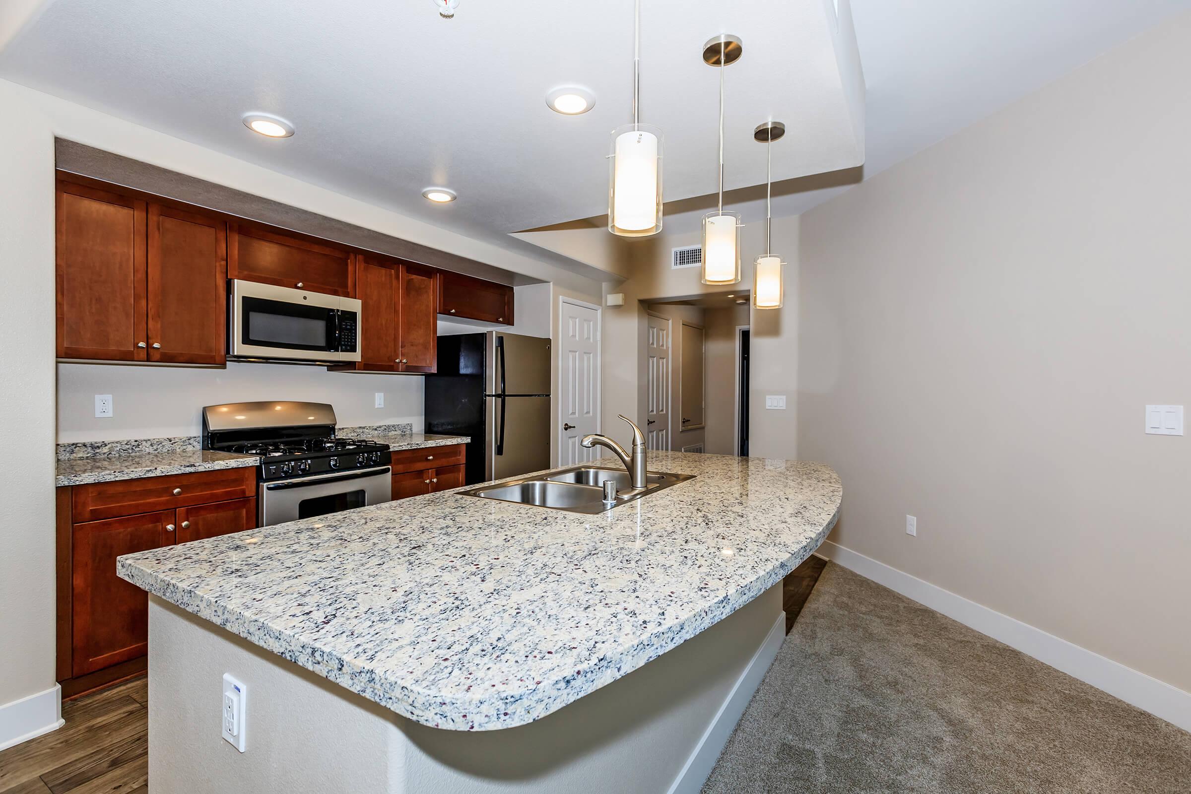 a kitchen with a sink and a mirror