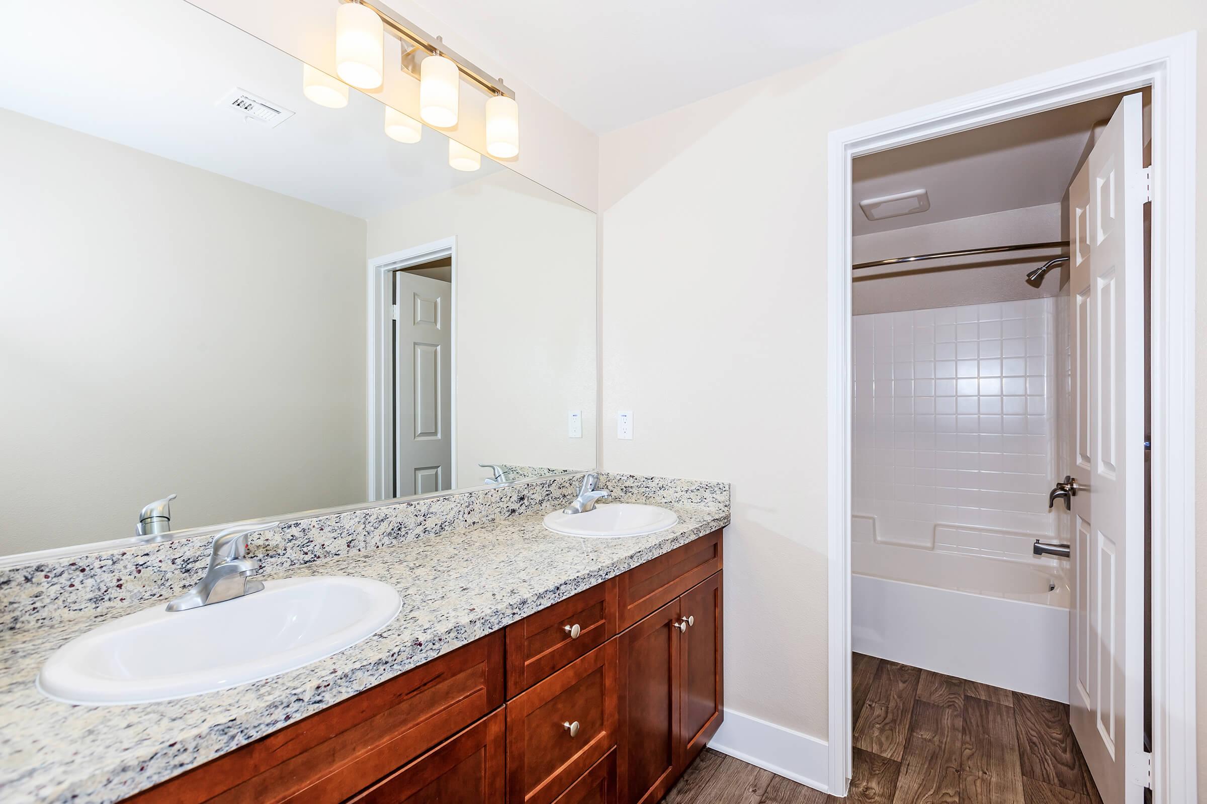 a kitchen with a sink and a mirror