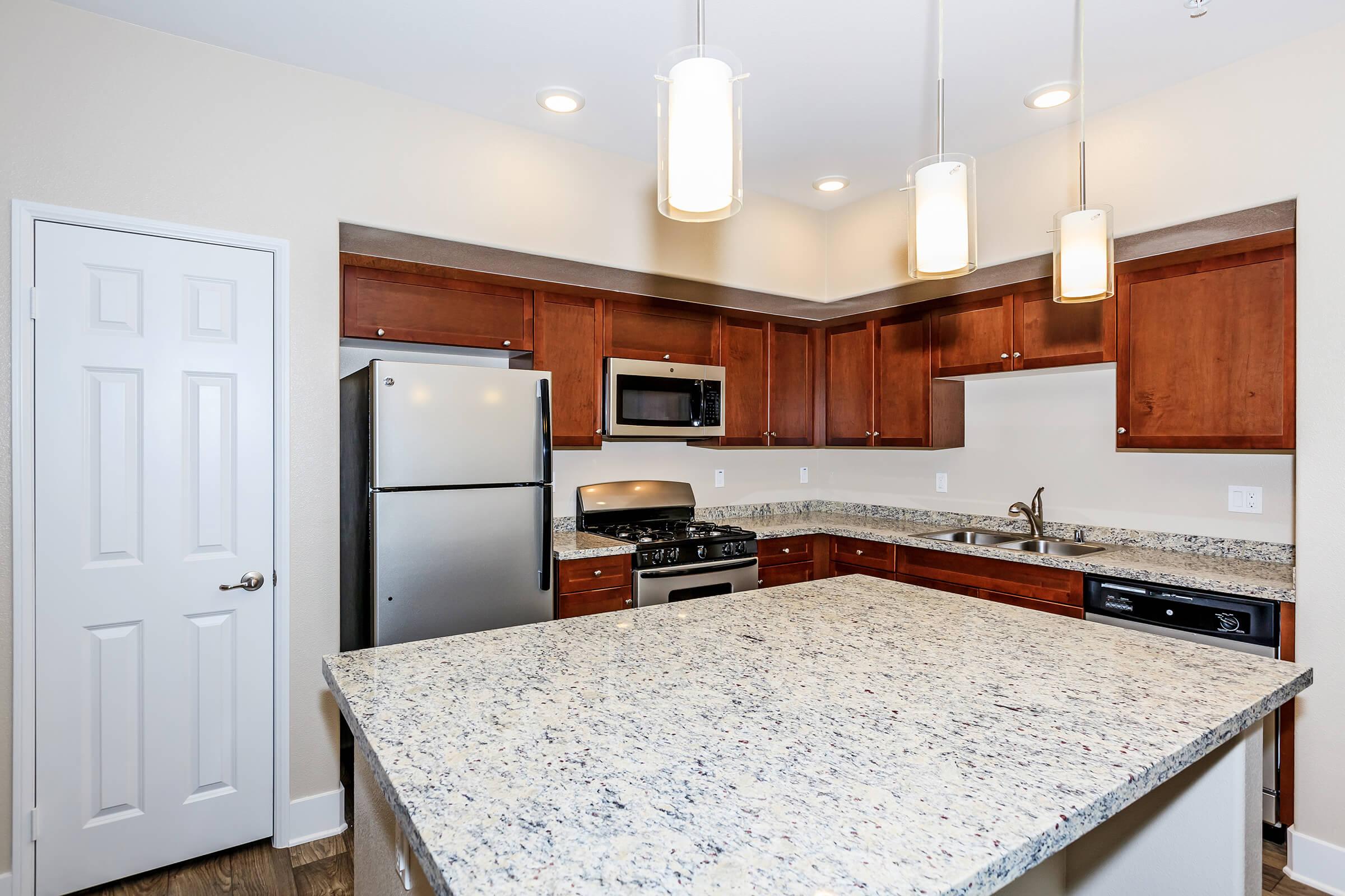 a kitchen with an island in the middle of a room