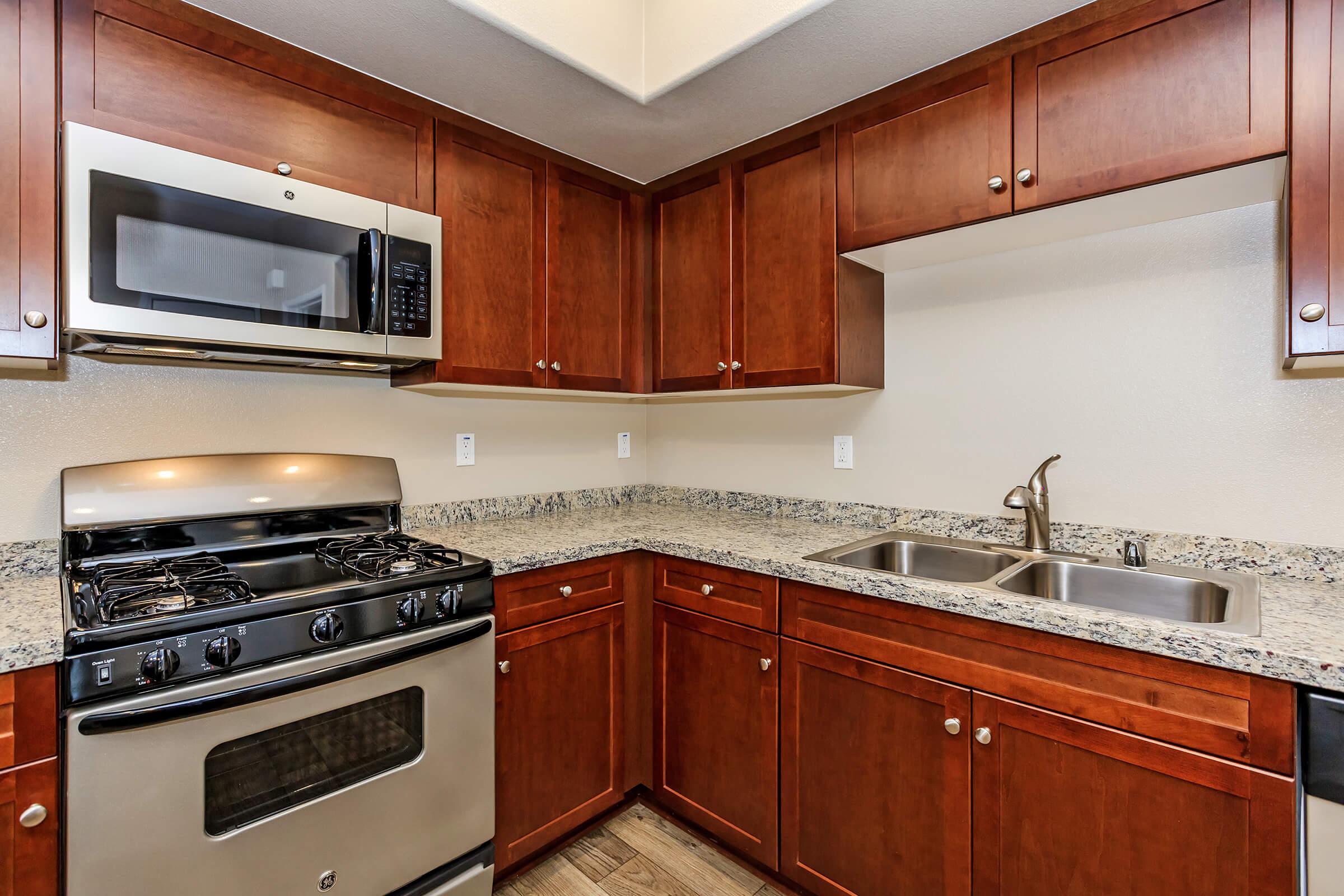 a kitchen with stainless steel appliances and wooden cabinets