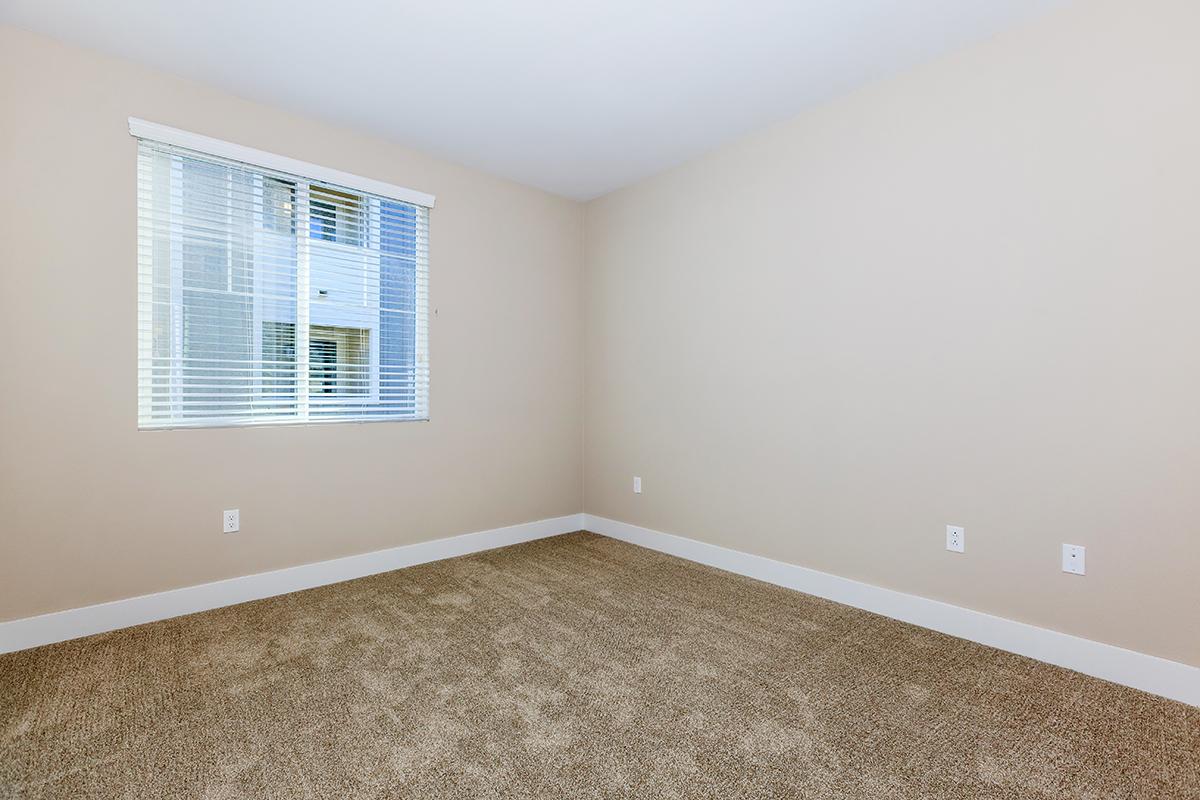 Unfurnished carpeted bedroom with a window