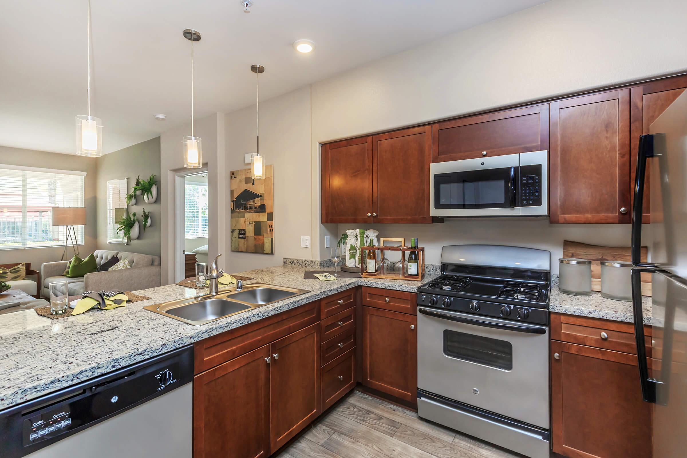 a modern kitchen with stainless steel appliances and wooden cabinets