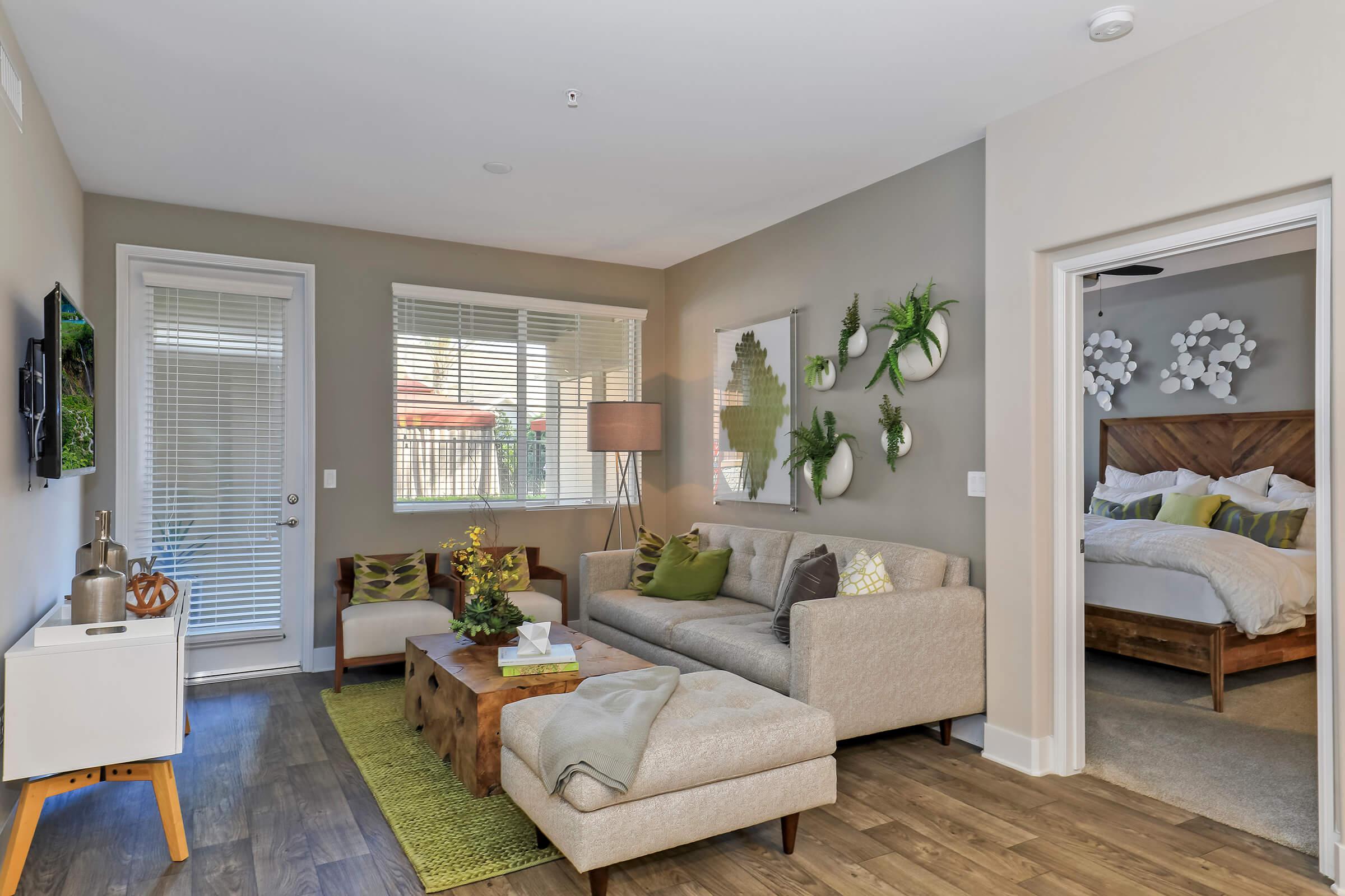 a living room filled with furniture and a large window