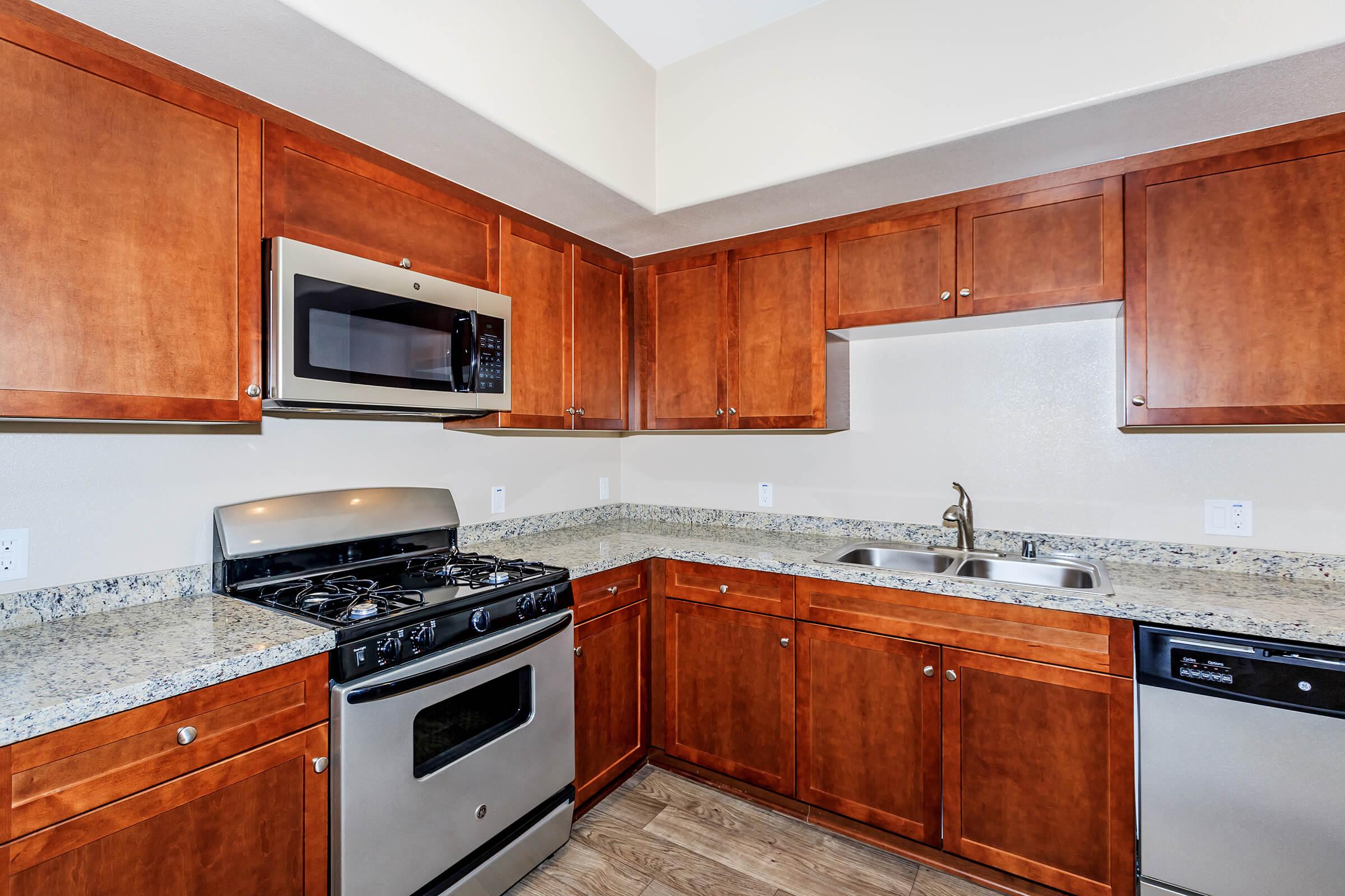 a kitchen with stainless steel appliances and wooden cabinets