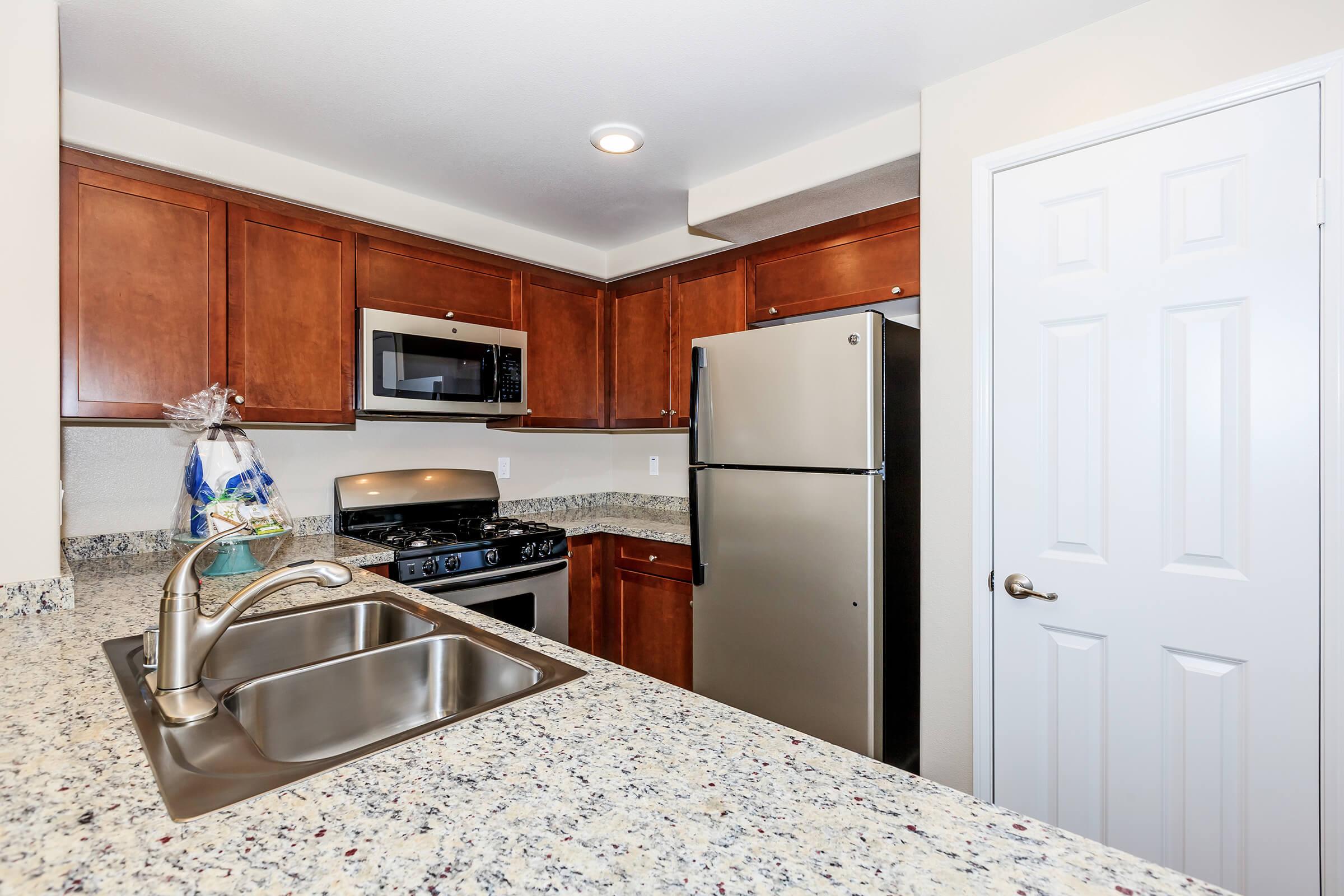 a kitchen with a sink and a refrigerator